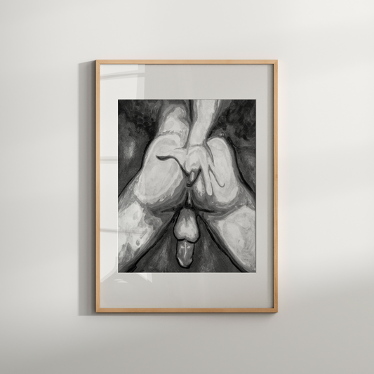 Framed black and white artwork of hands holding a heart on a light gray wall.