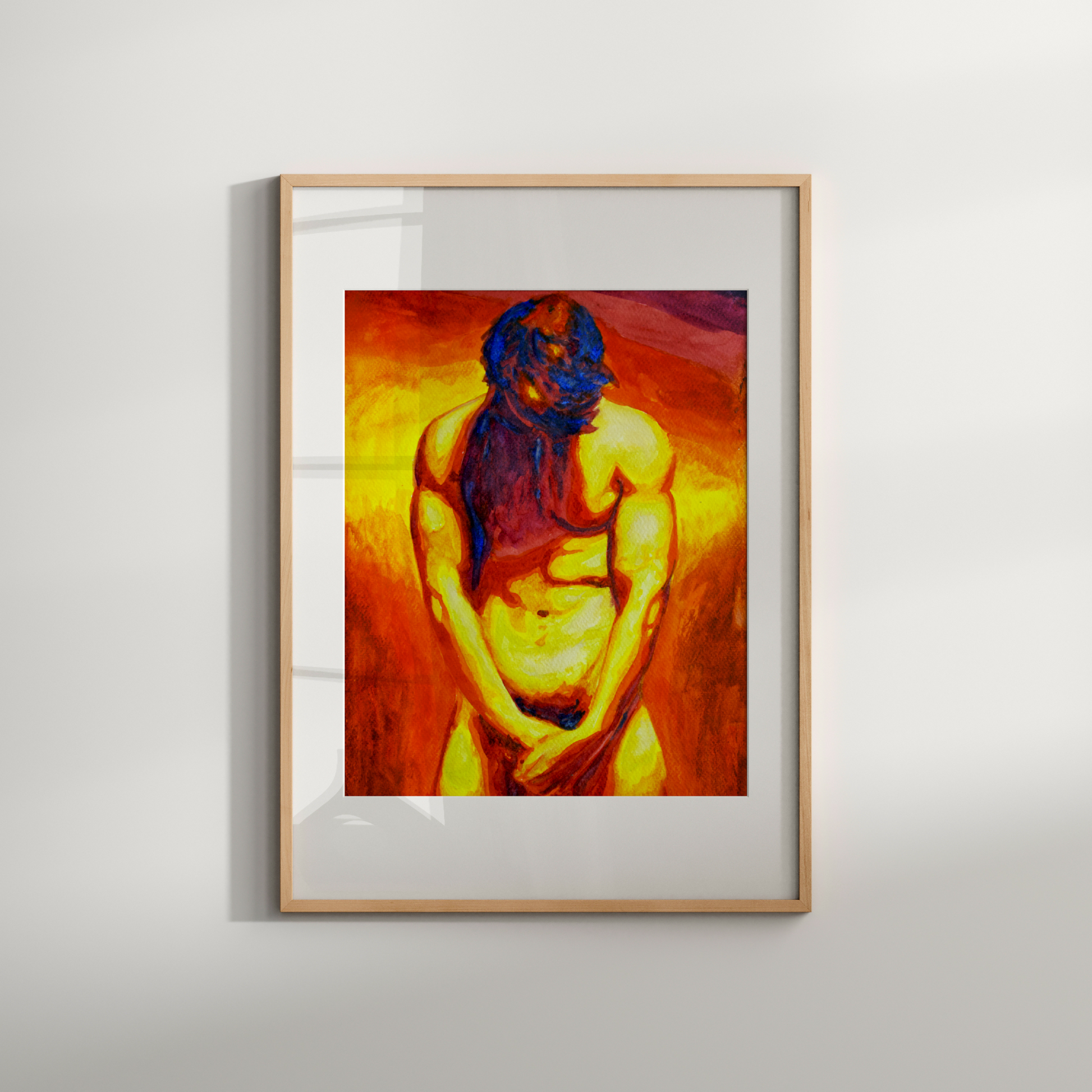 Framed artwork of a nude figure with a warm color palette on a light gray wall.