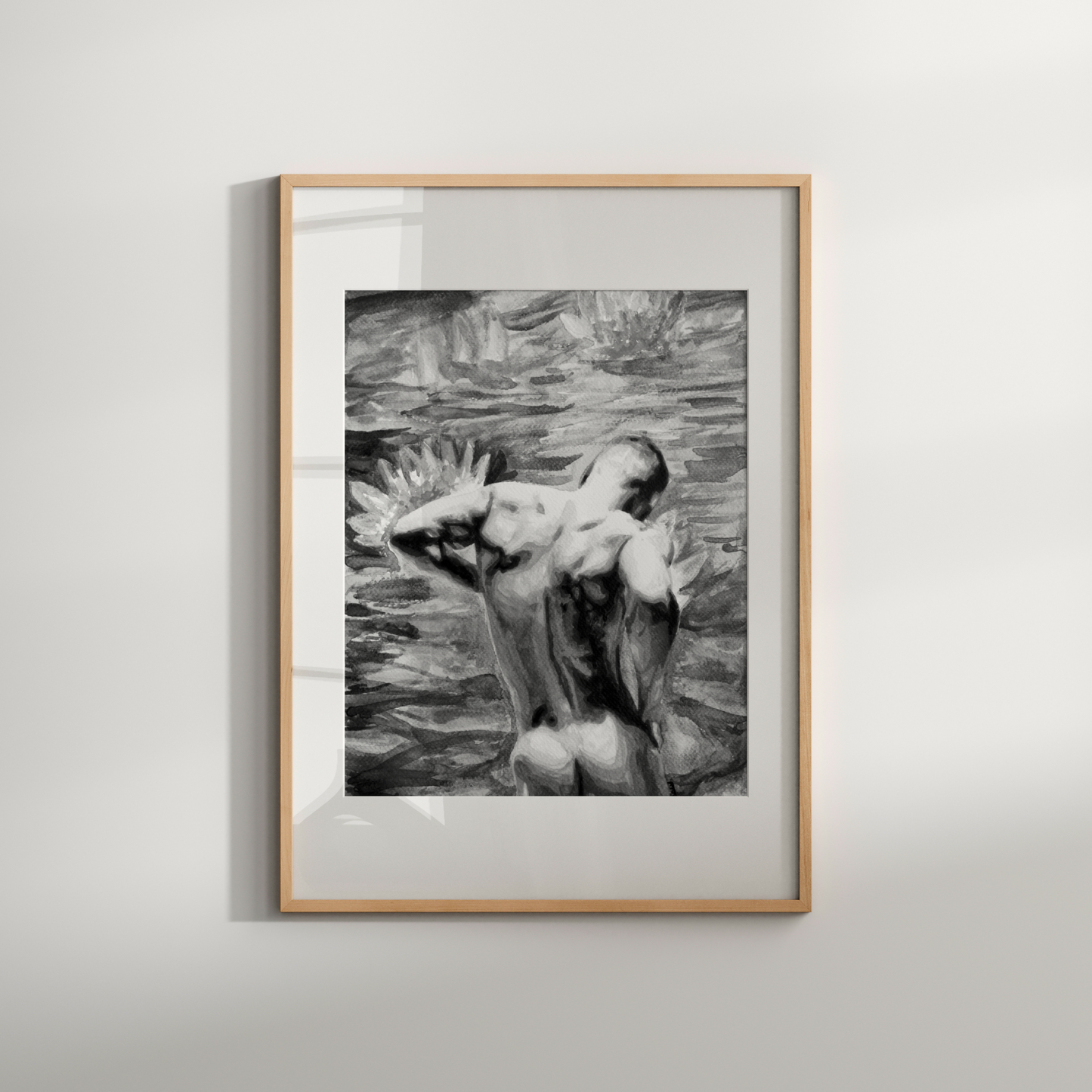 Framed black and white artwork of a nude figure in water on a light gray wall.
