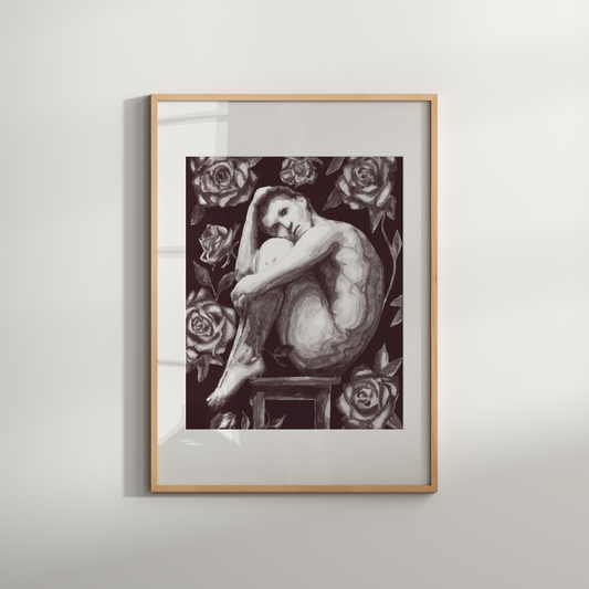 Framed artwork of a nude figure with floral elements on a white wall