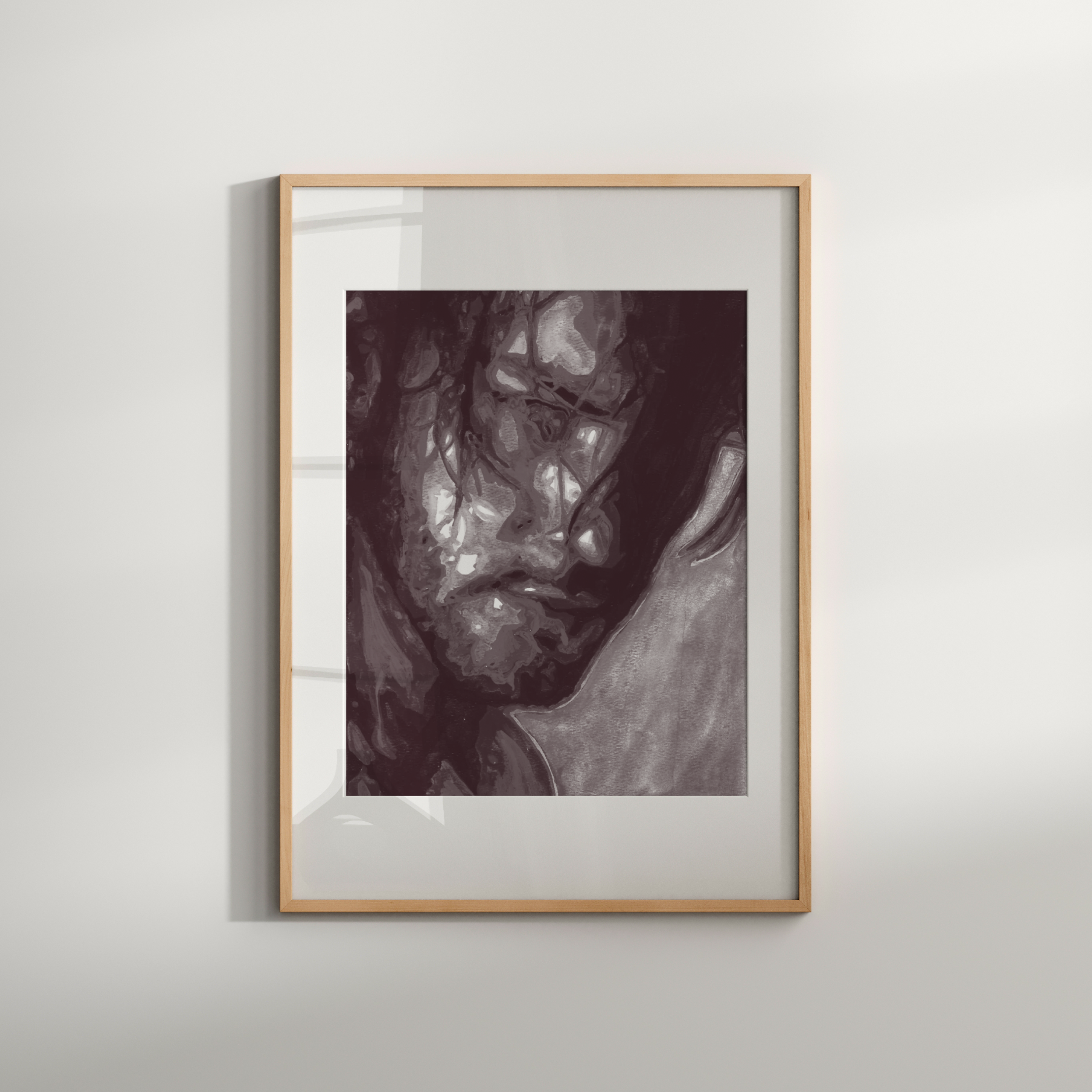 Framed artwork of a woman's face on a white wall