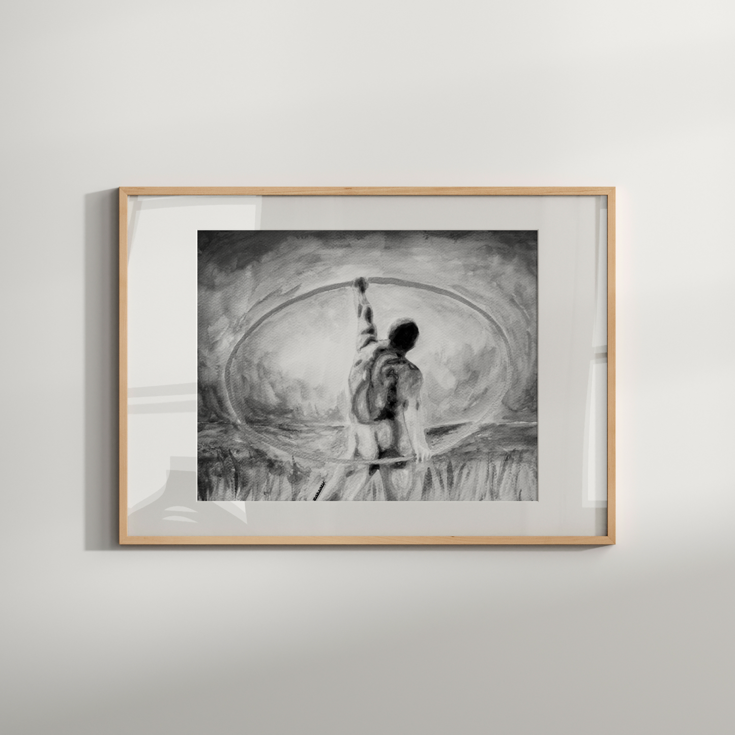 Framed black and white artwork of a person with a bow and arrow on a light gray wall.