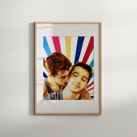 Framed artwork of two people embracing with a colorful abstract background on a white wall.