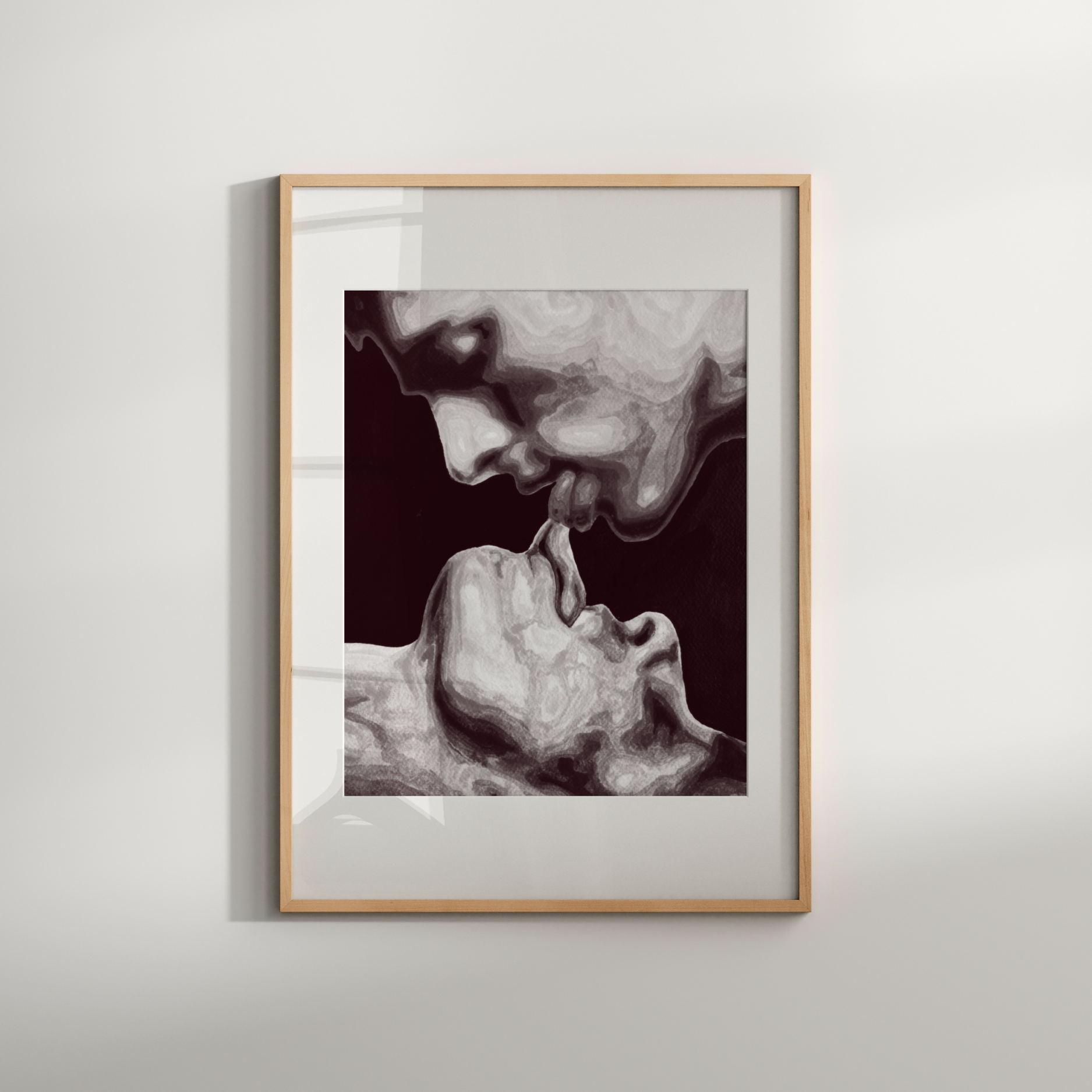 Framed artwork of a face and hand on a white wall