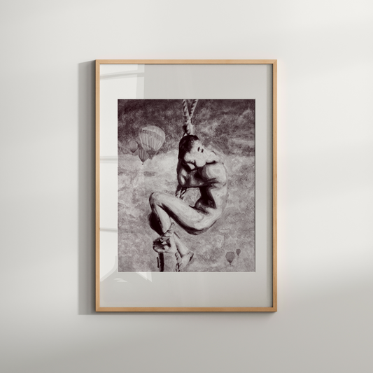 Framed black and white artwork of a person on a wall