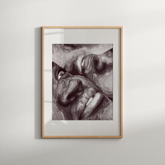 Framed black and white artwork of a face on a light gray wall