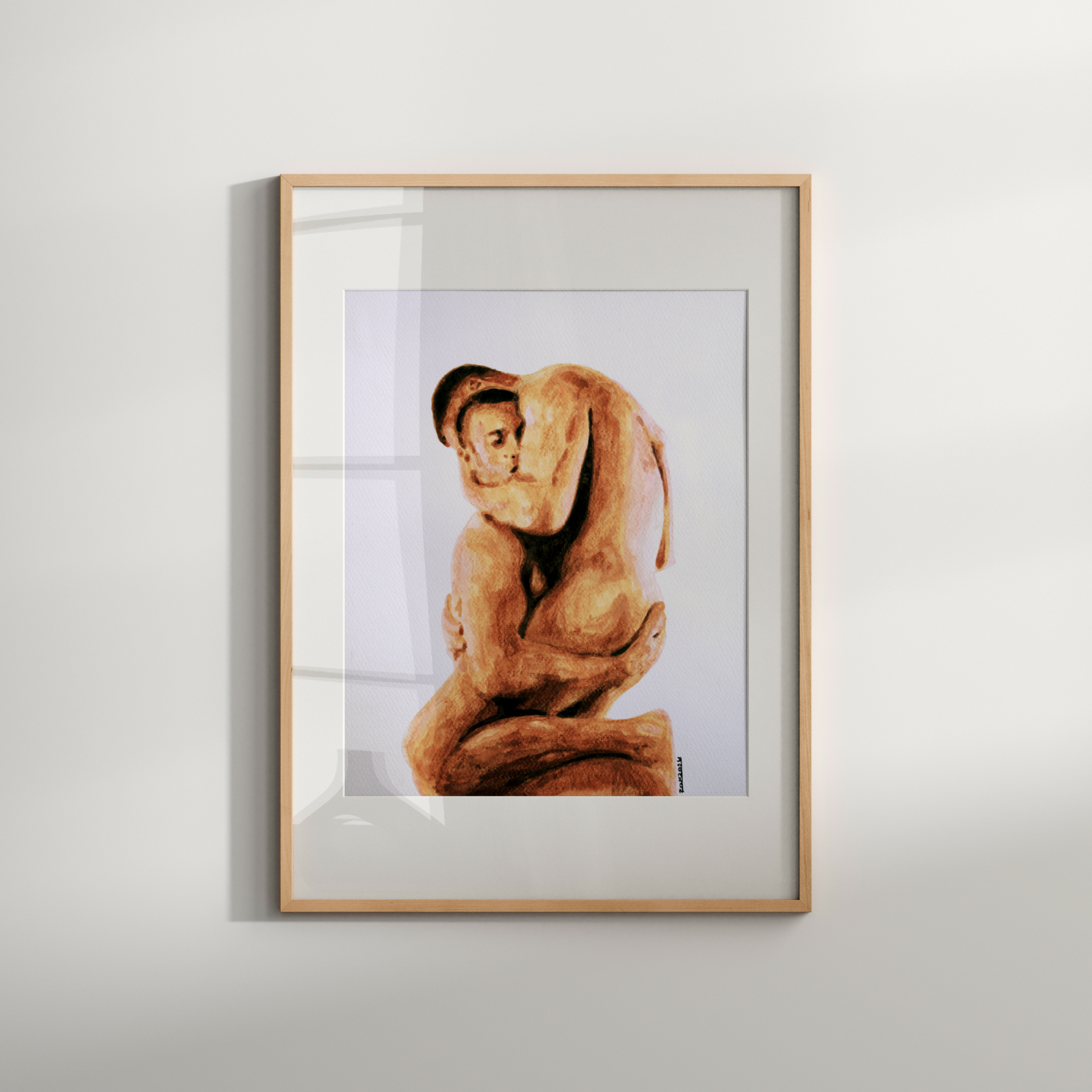 Framed artwork of a person in a sitting pose on a white wall