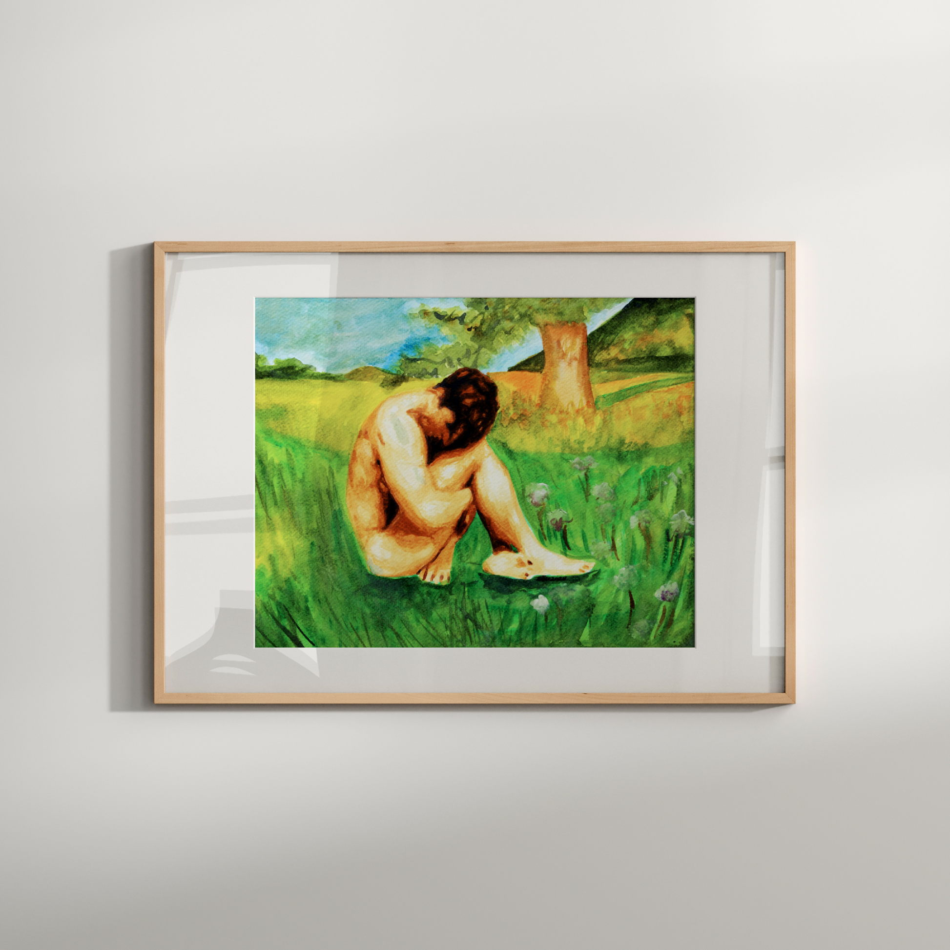 Framed artwork of a nude figure in a field on a white wall