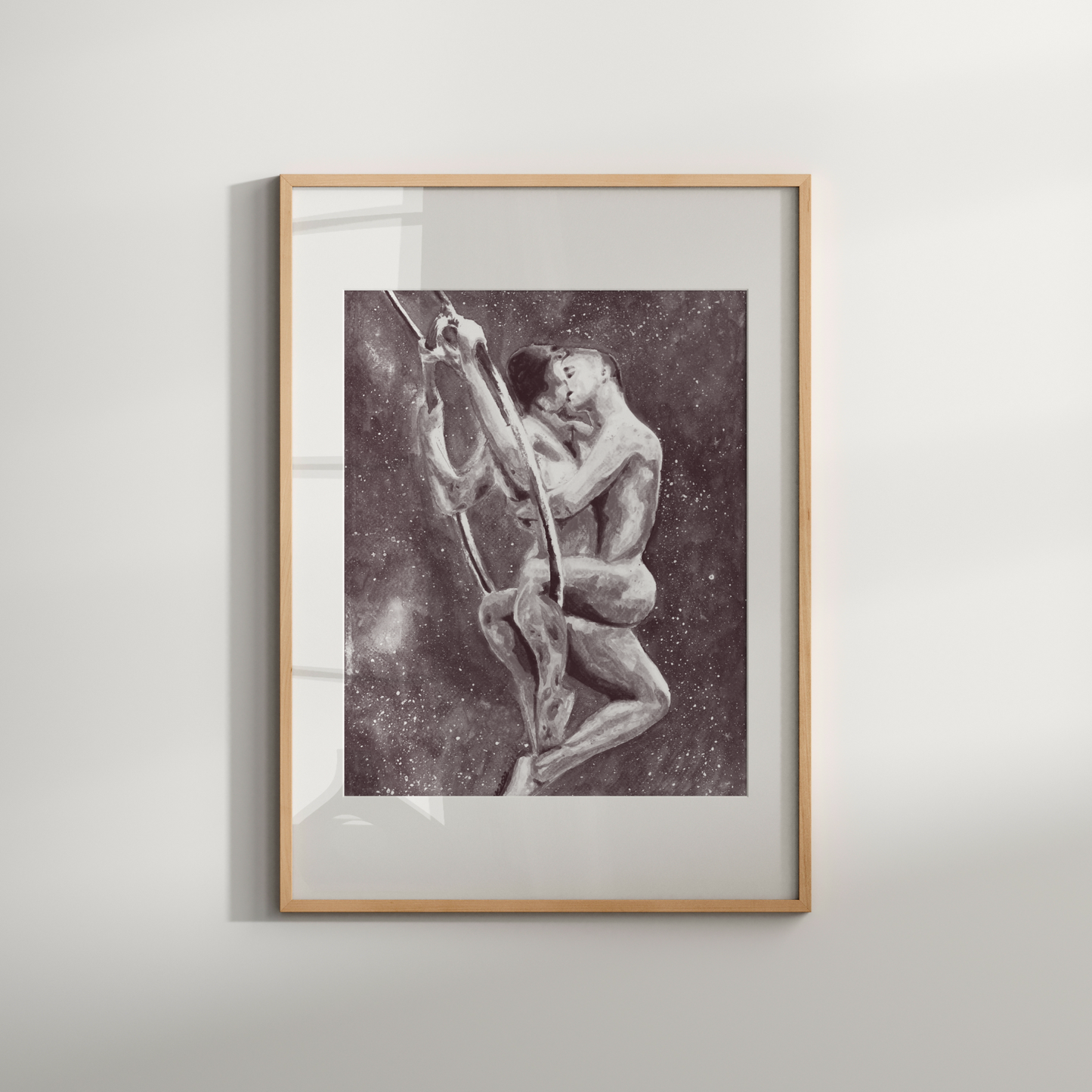 Framed black and white artwork of two figures on a plain wall