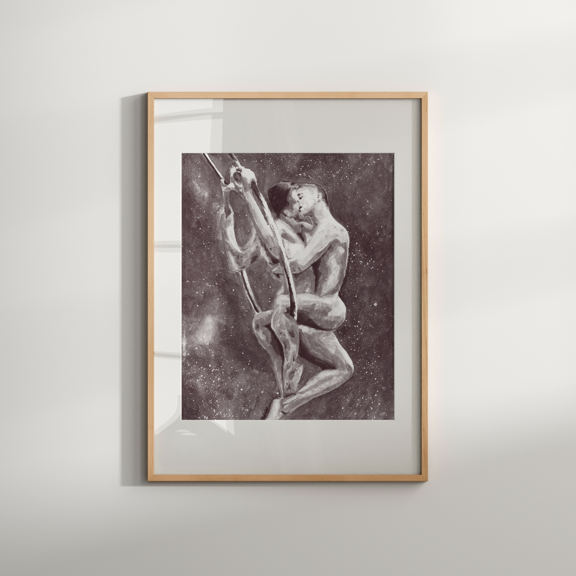 Framed black and white artwork of two figures on a plain wall