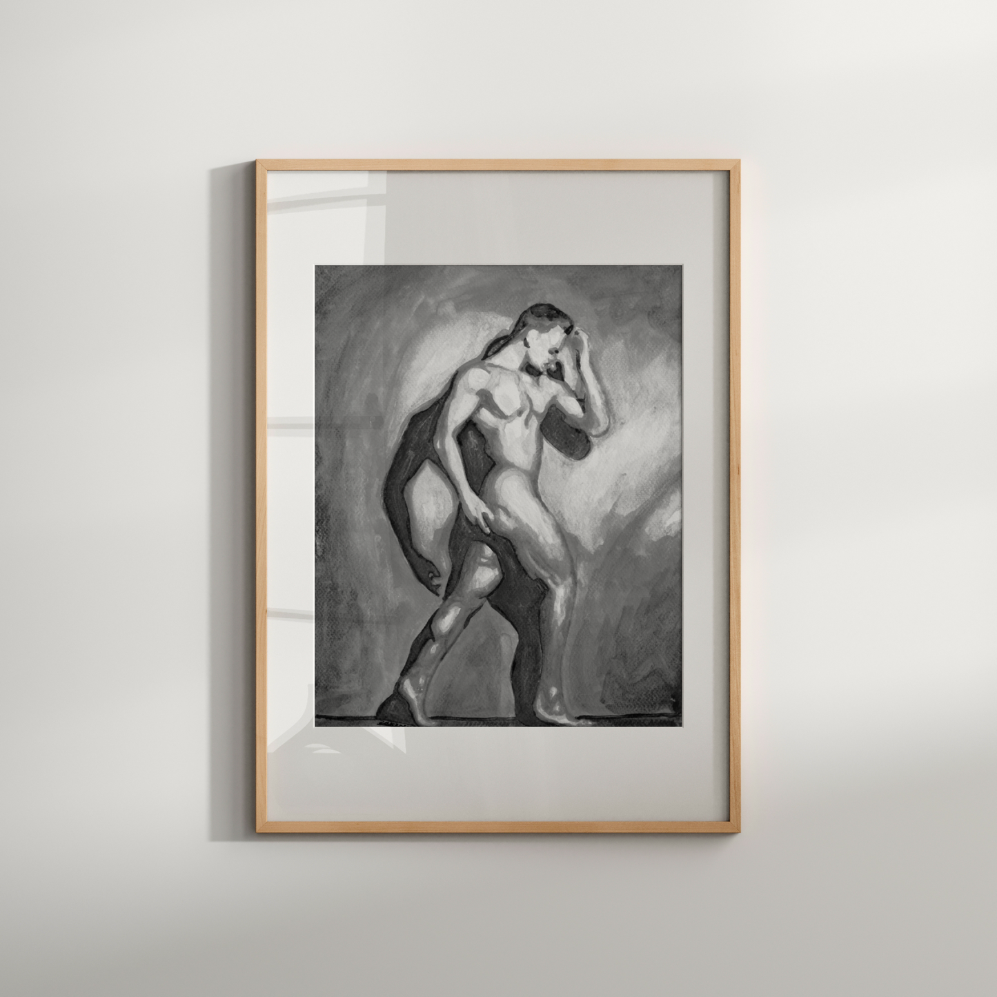 Framed artwork of a nude figure on a plain wall