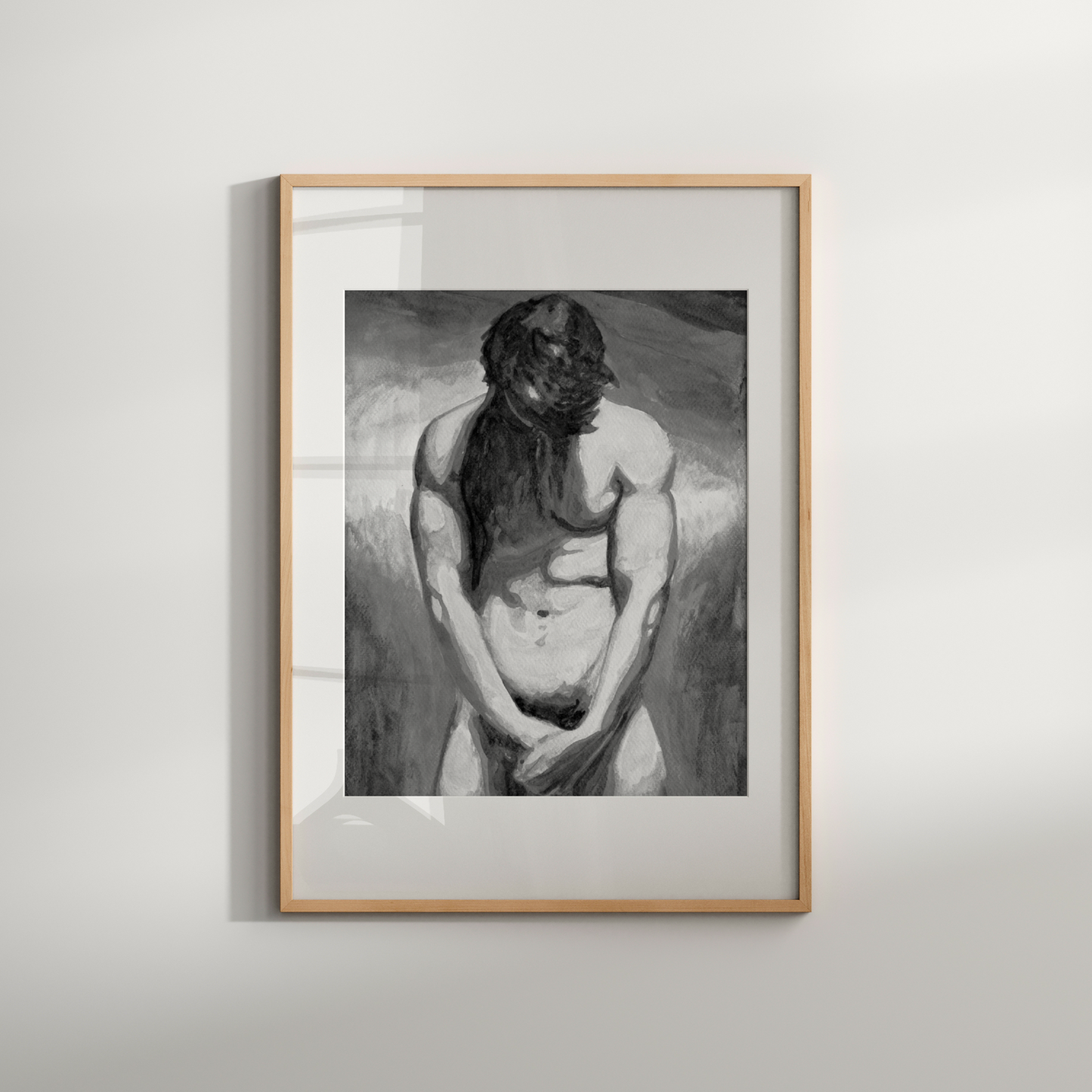 Framed black and white artwork of a nude figure on a light gray background