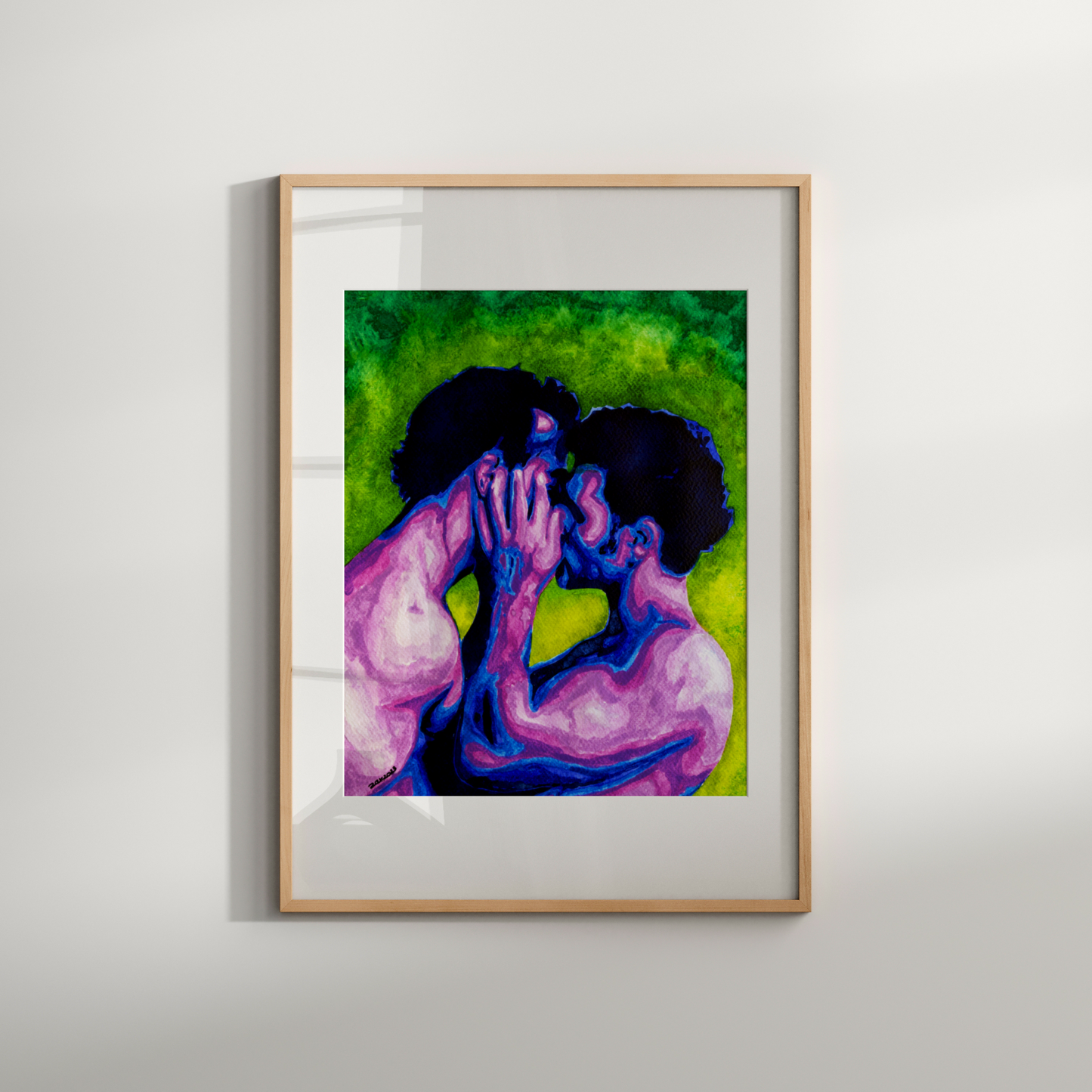 Framed artwork of two people embracing on a white wall