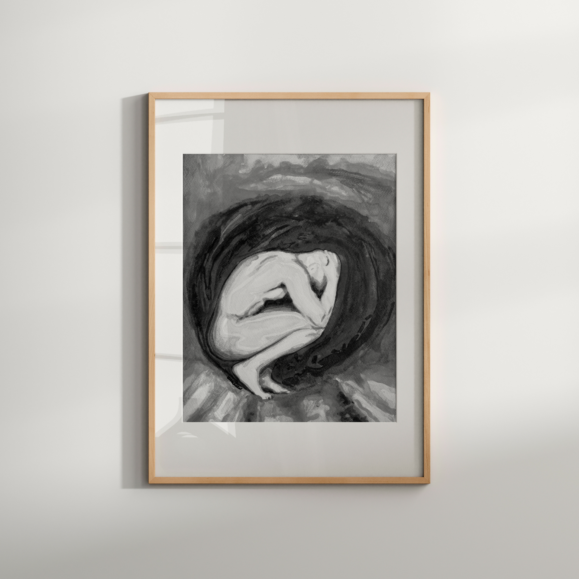 Framed black and white artwork of a woman with flowing hair on a light gray wall.