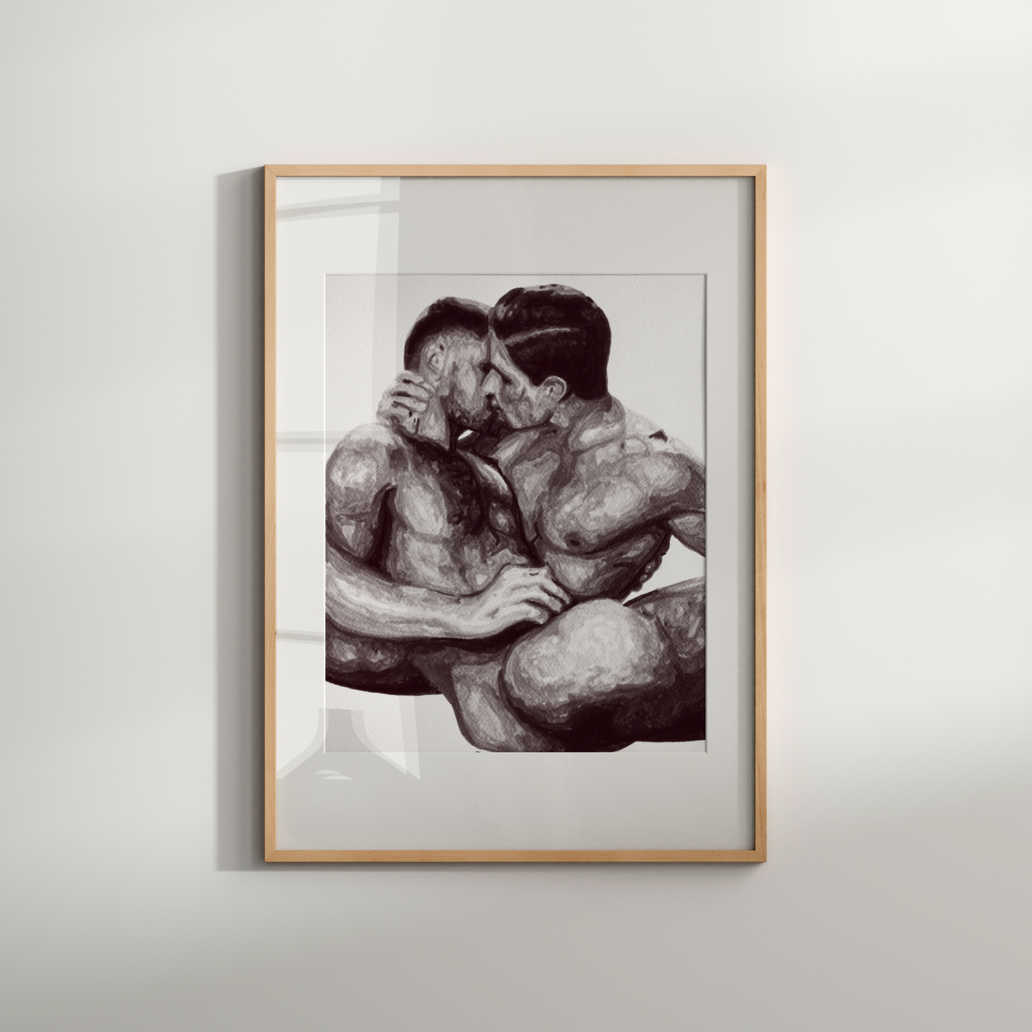 Framed artwork of two people embracing on a white wall