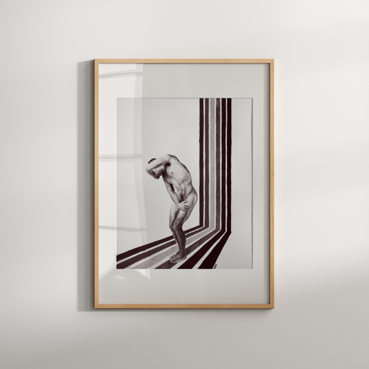 Framed artwork of a nude figure in a minimalist setting on a white wall