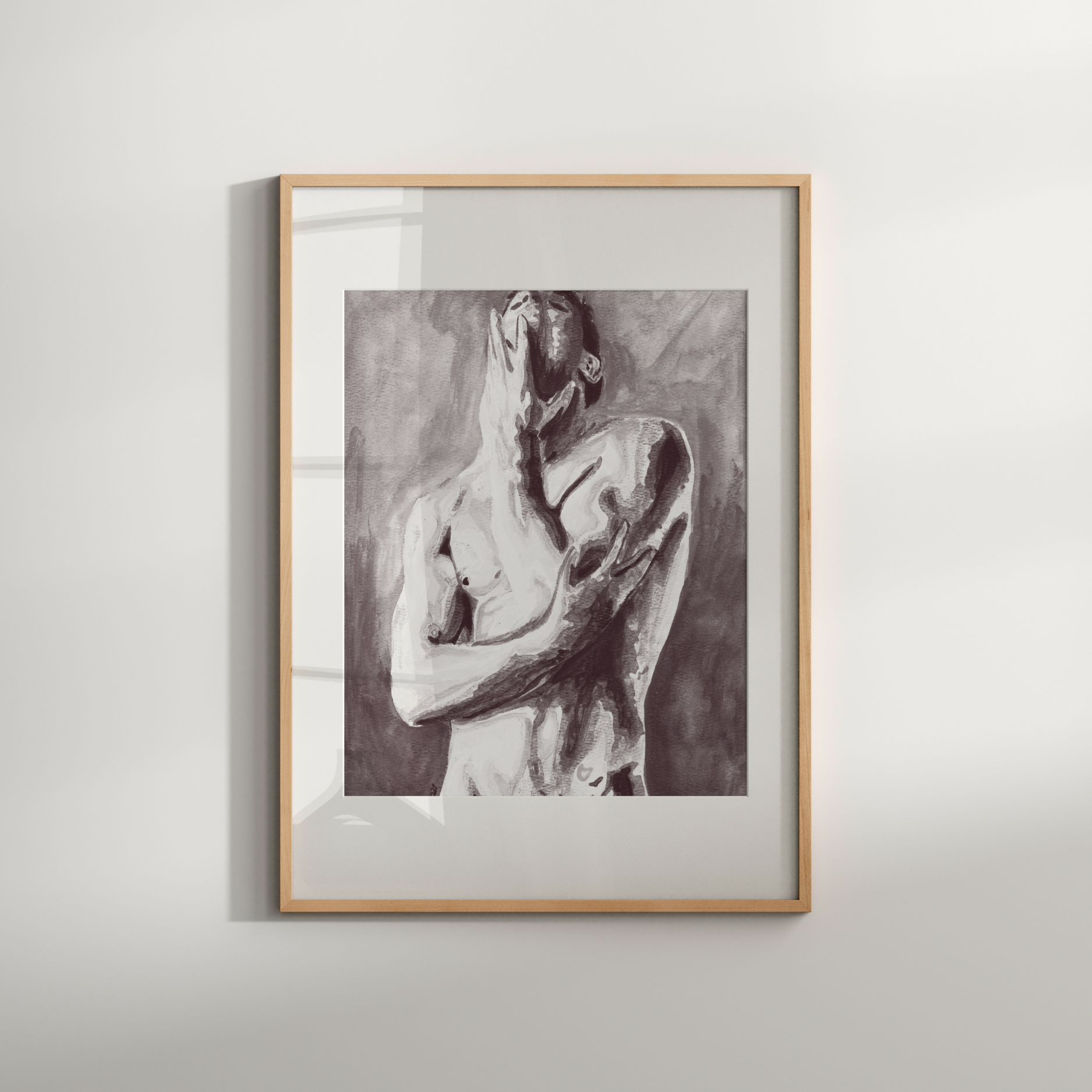 Framed artwork of a nude figure on a white wall