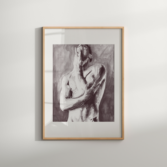 Framed artwork of a nude figure on a white wall