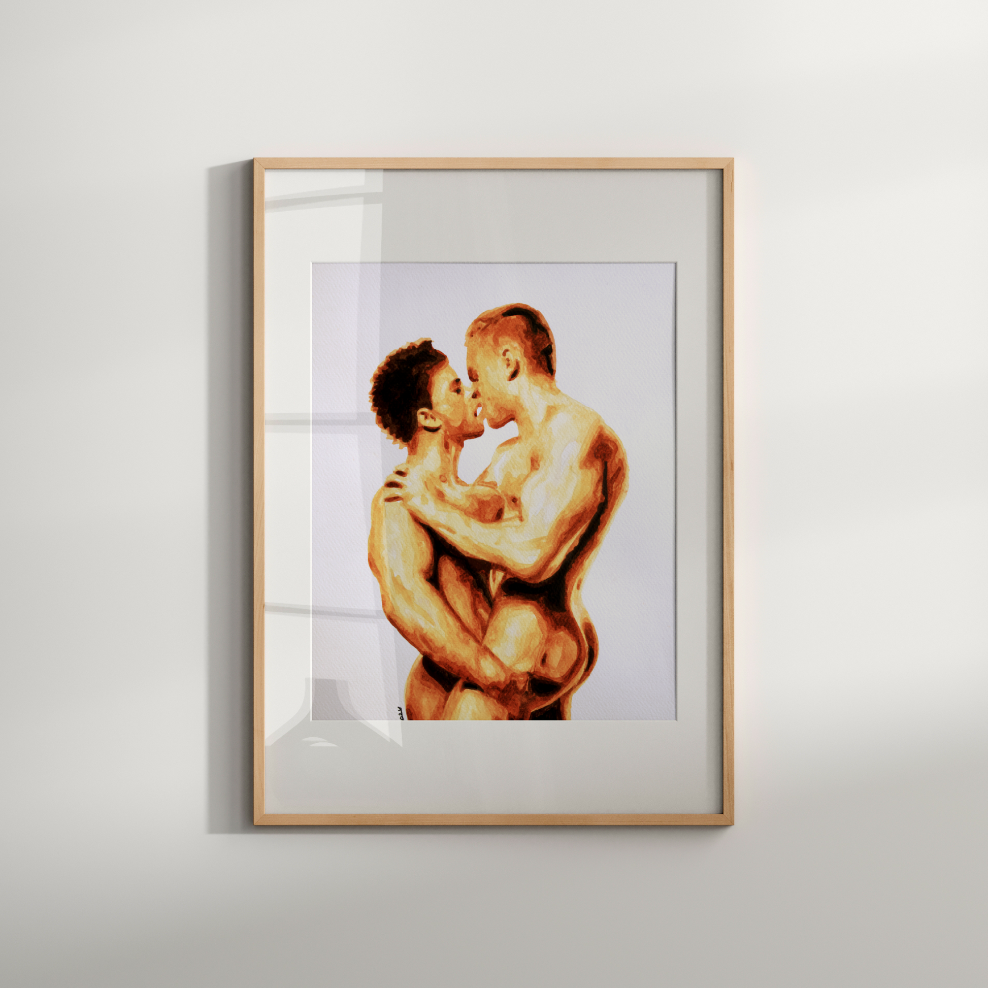 Framed artwork of two people embracing on a white wall