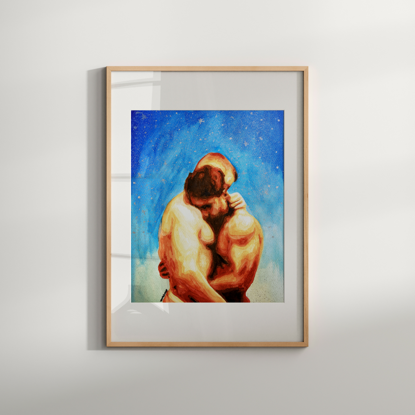 Framed artwork of two people embracing against a starry sky on a white wall.