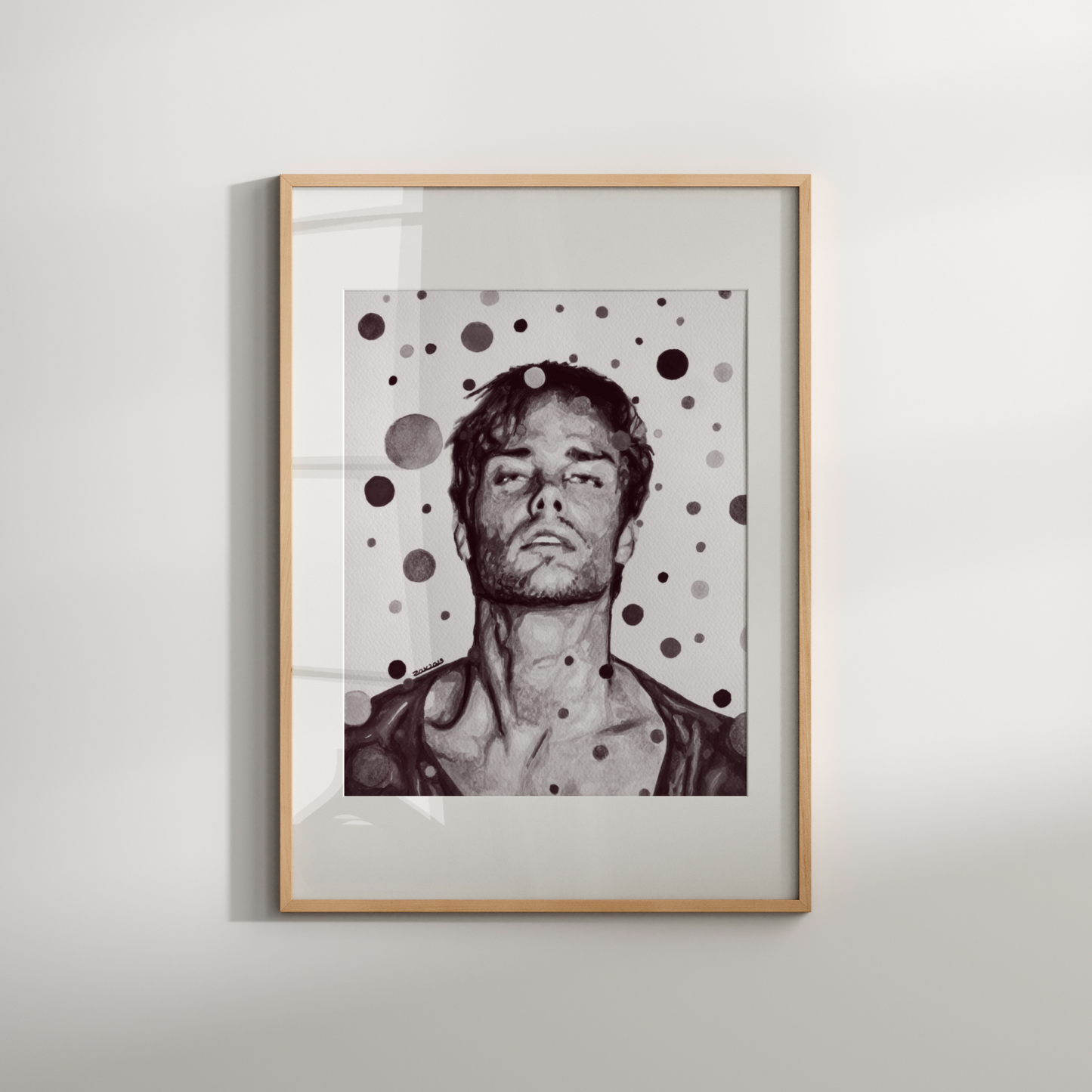Framed artwork of a person with polka dot pattern on a white wall