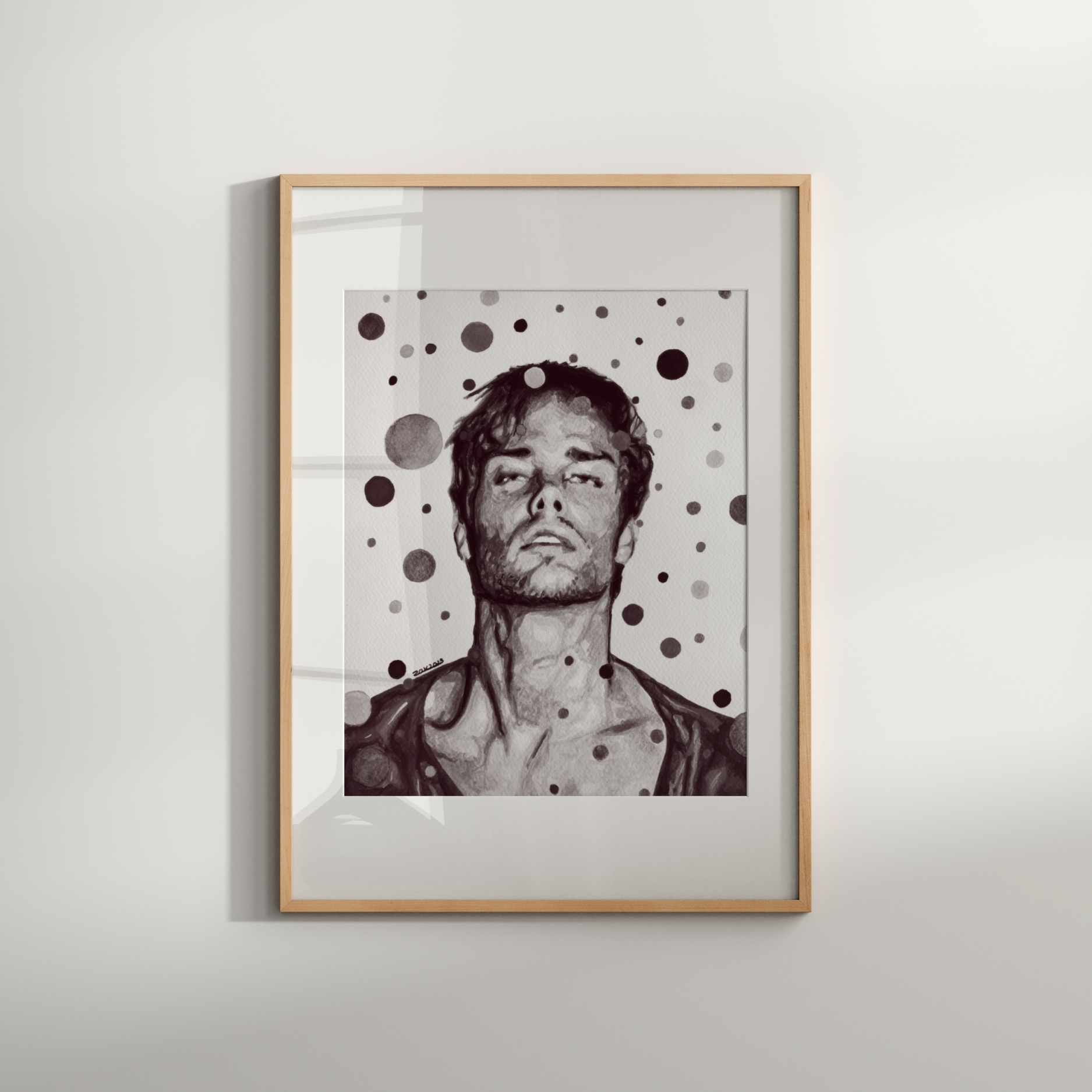 Framed artwork of a person with polka dot pattern on a white wall