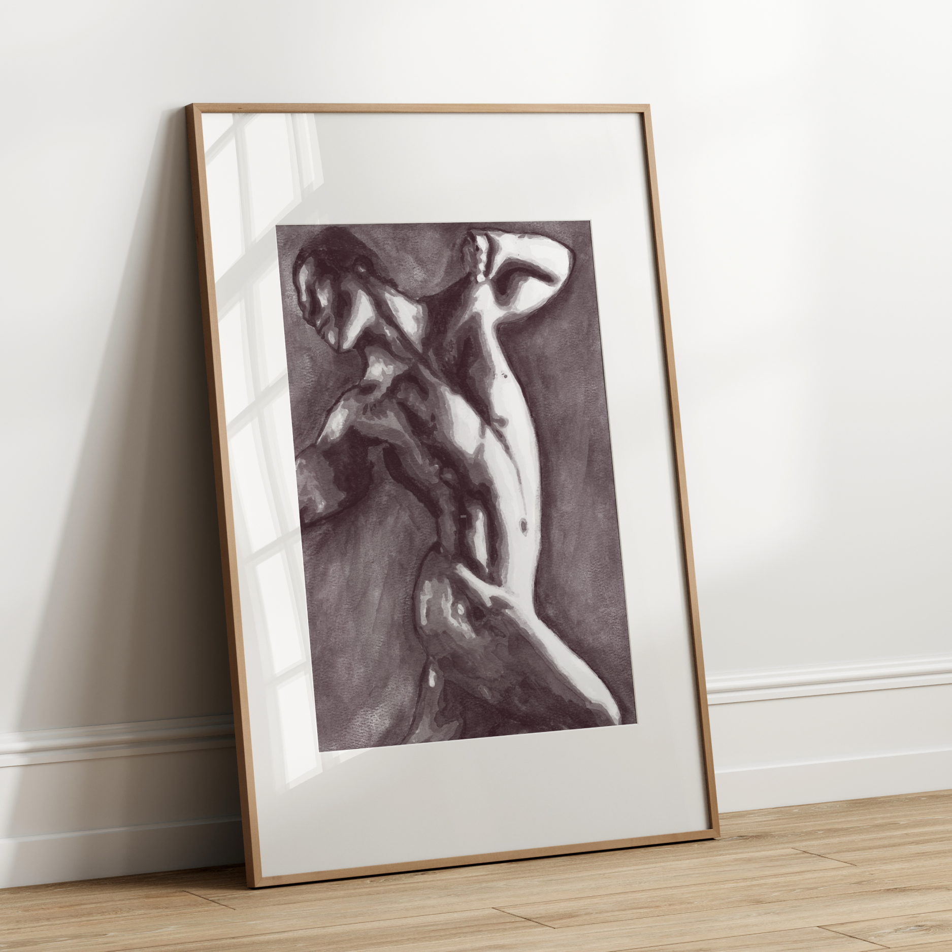 Framed black and white artwork of a nude figure leaning against a wall.