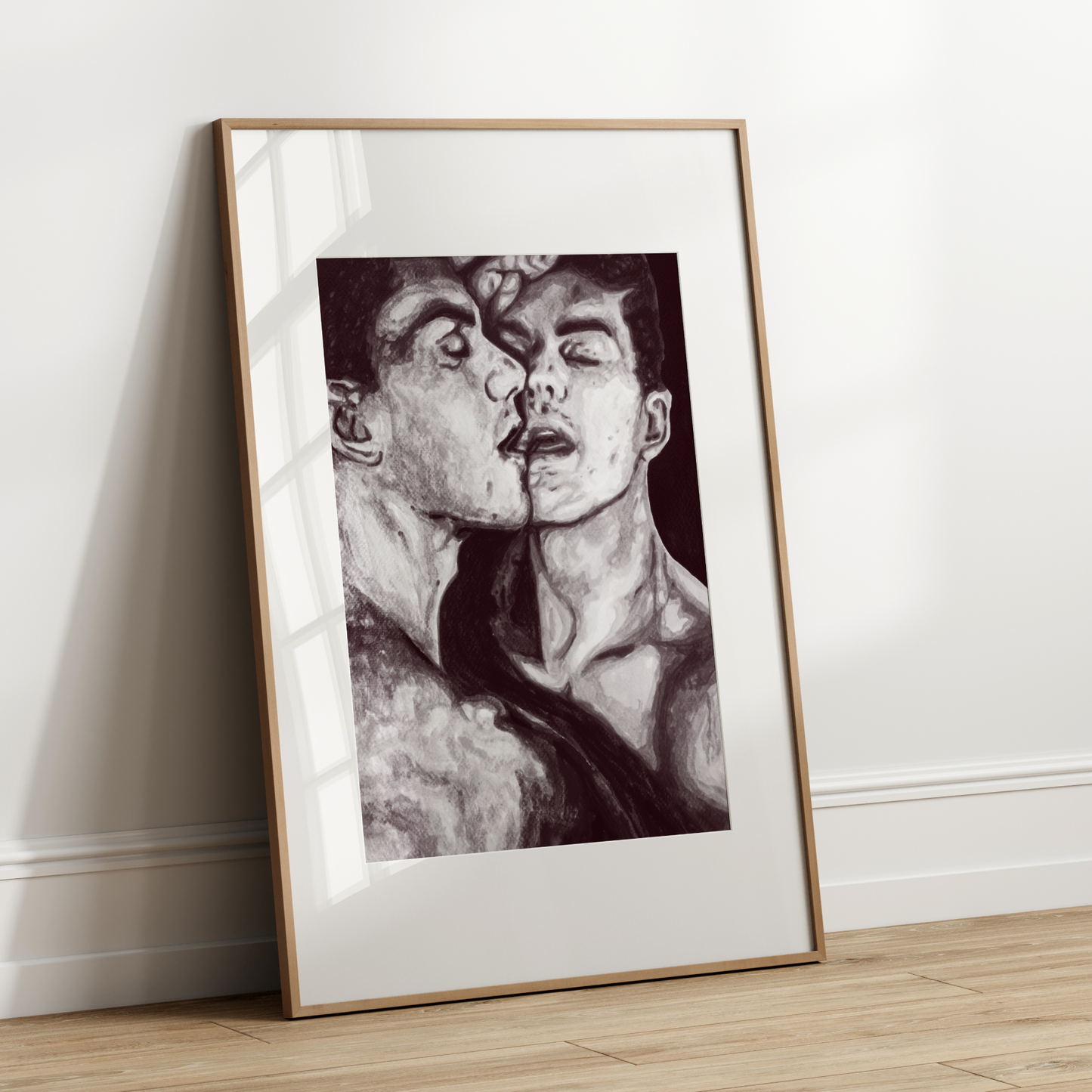 Framed black and white artwork of a person leaning forward against a white wall.