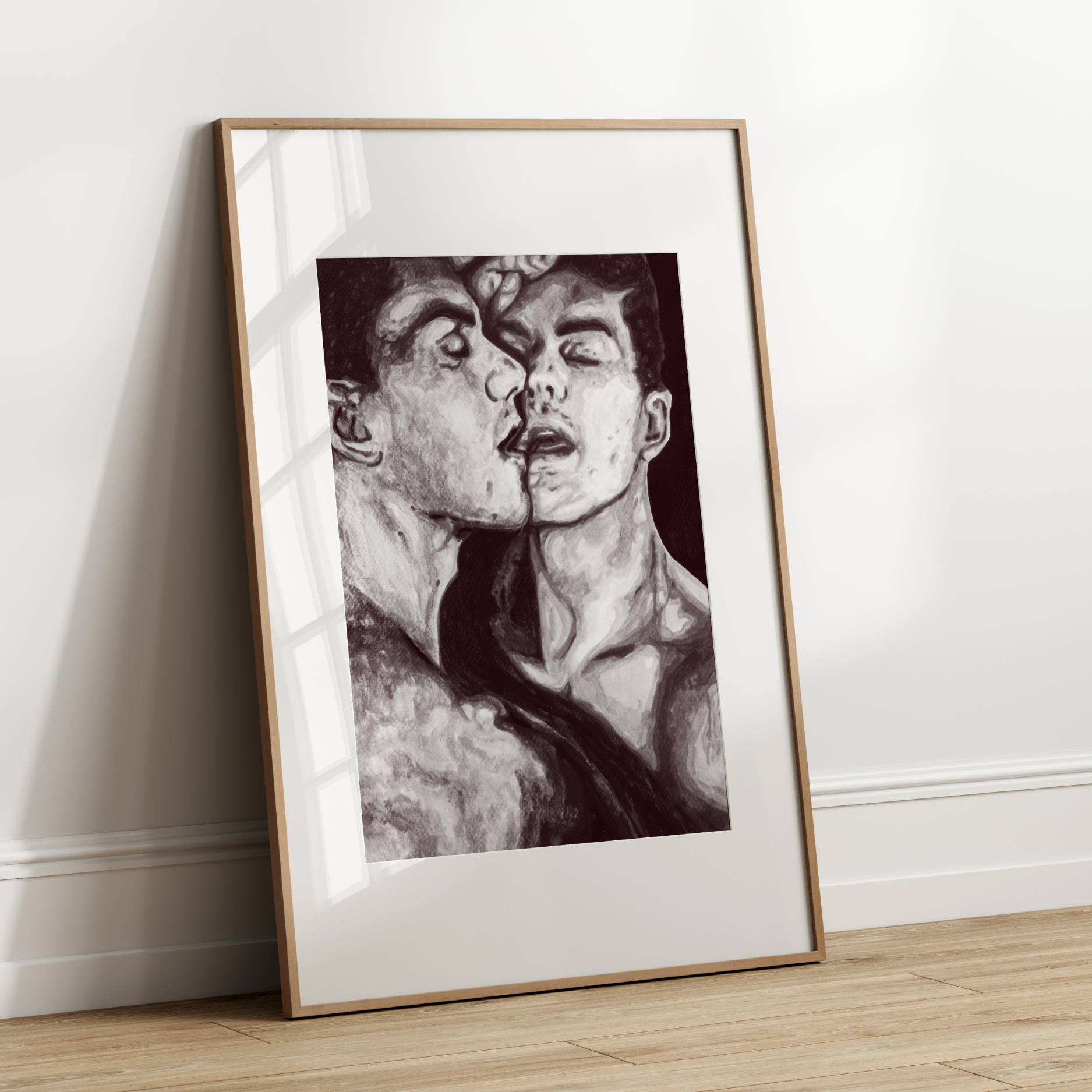 Framed black and white artwork of a person leaning forward against a white wall.