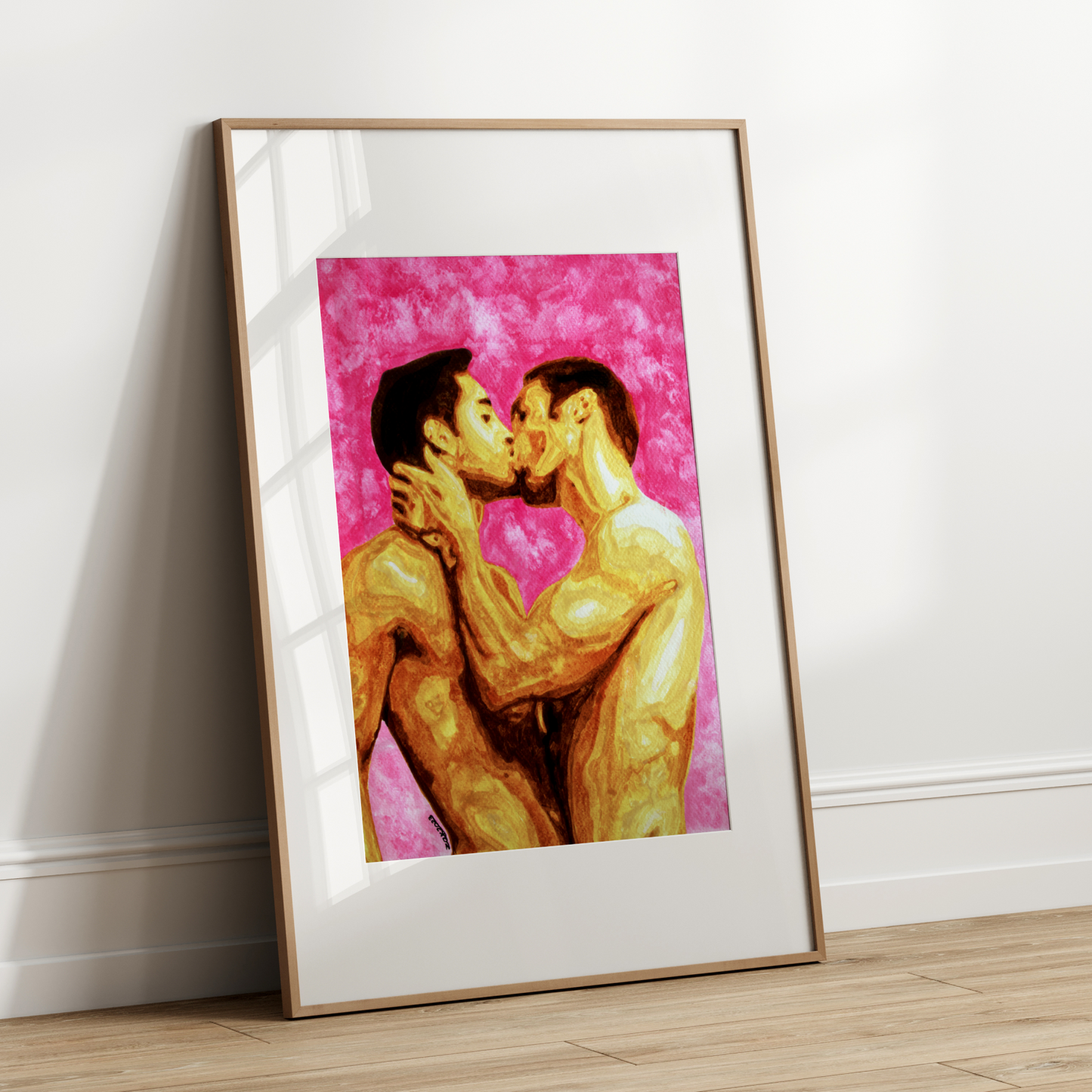 Framed artwork of two people kissing on a pink background against a white wall.