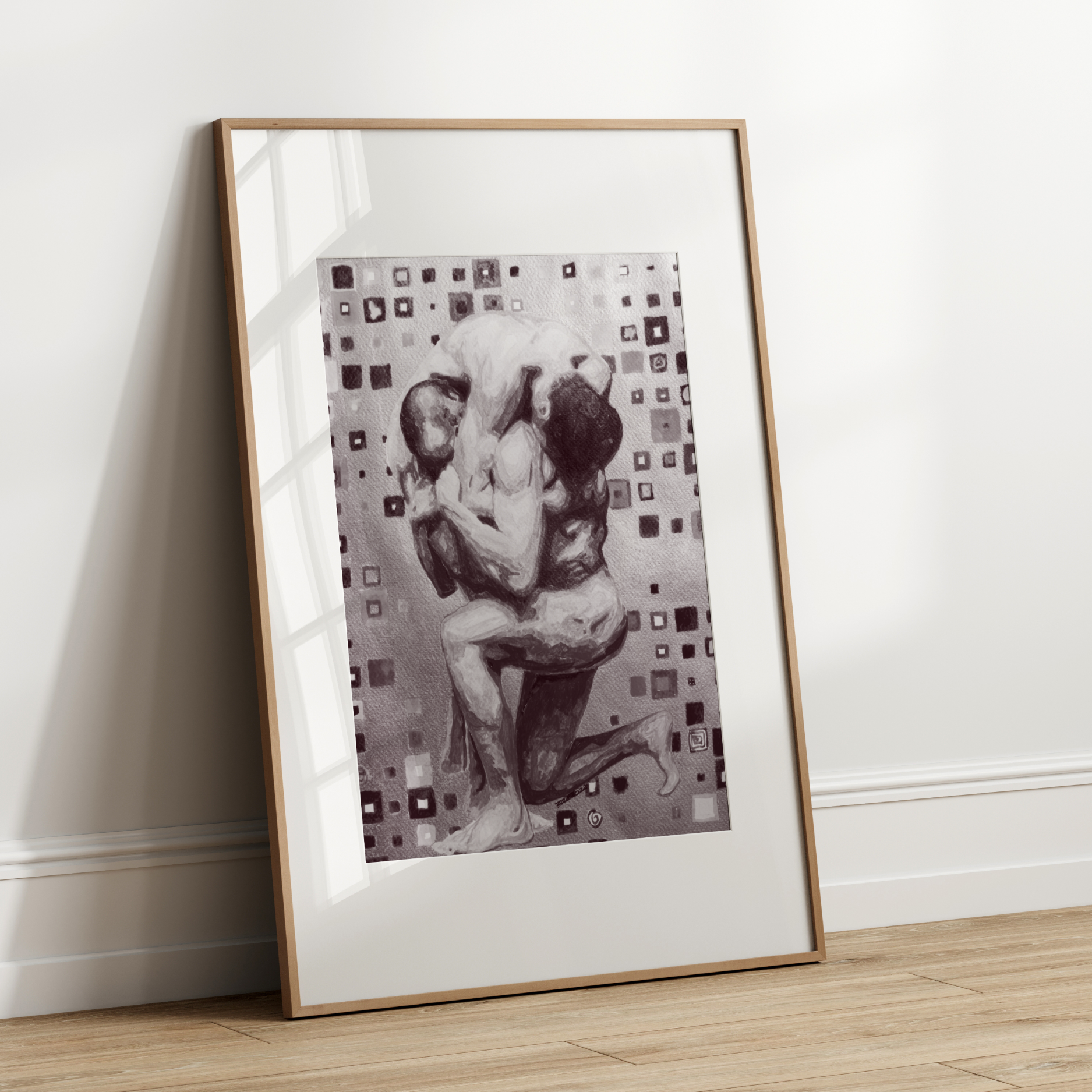 Framed artwork of a couple embracing on a white wall.