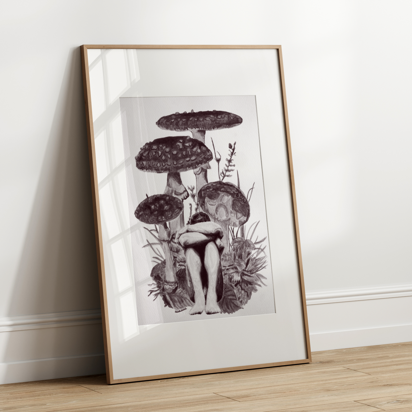 Framed black and white illustration of mushrooms on a white wall.