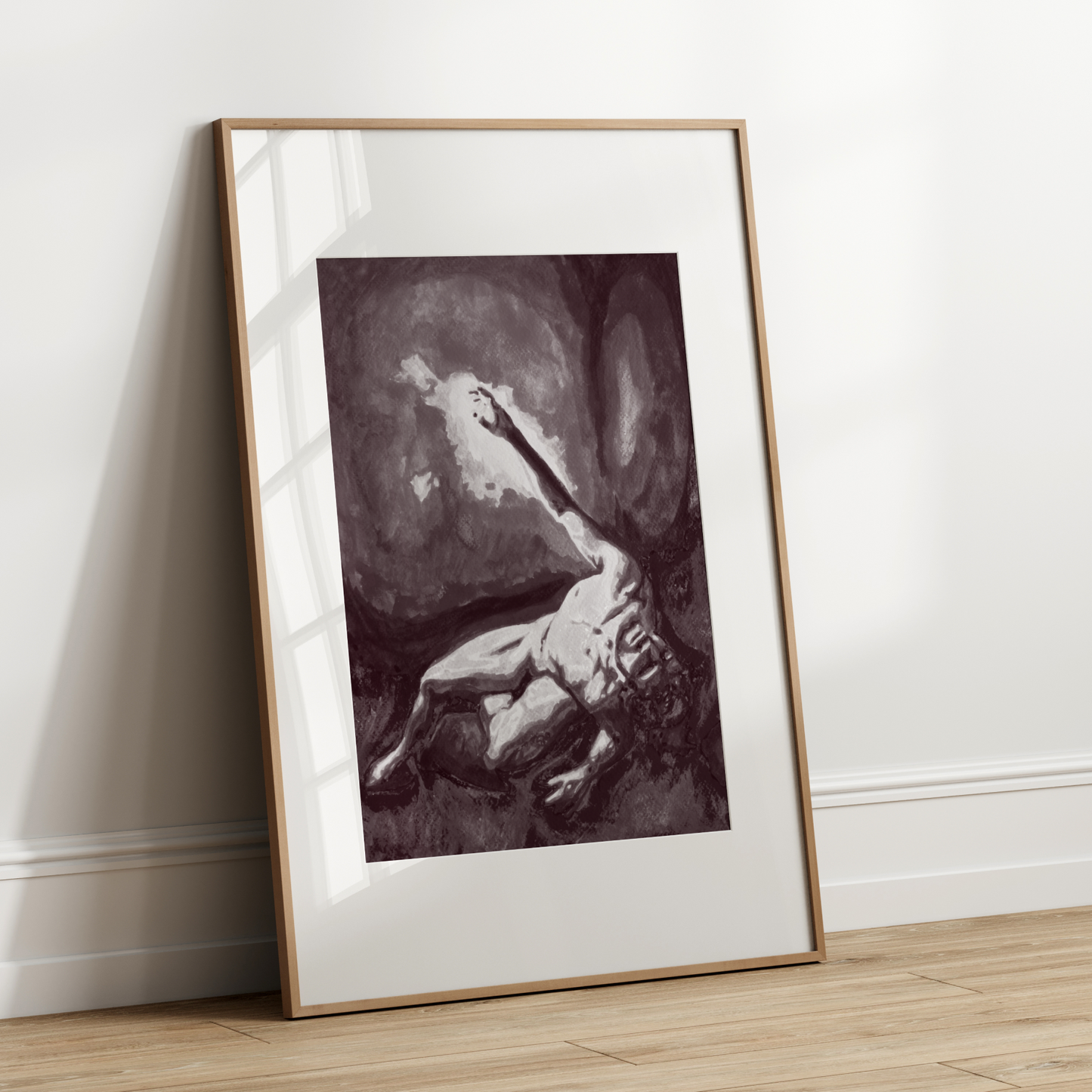 Framed artwork leaning against a white wall on a wooden floor