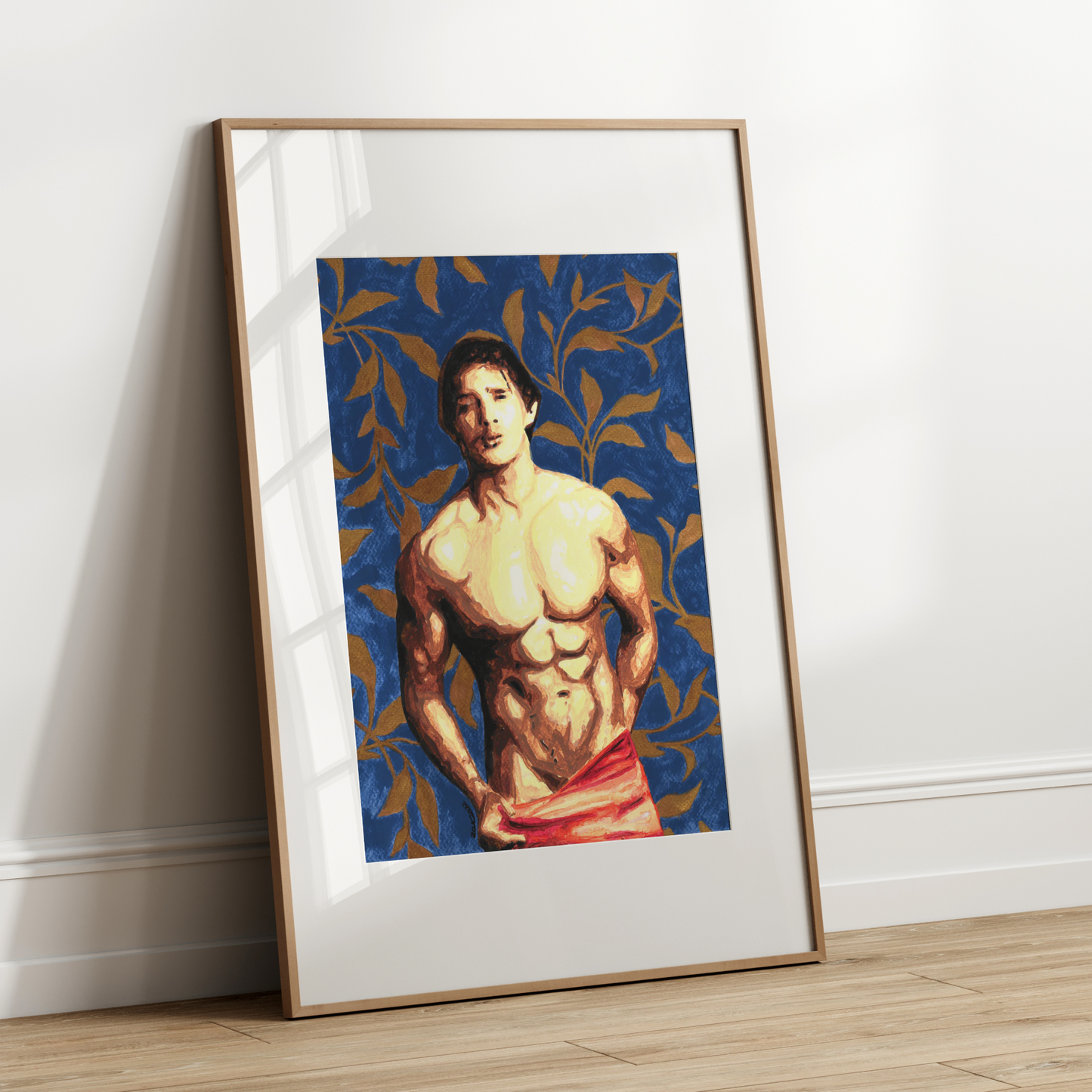Framed artwork of a shirtless man with a blue patterned background leaning against a white wall.