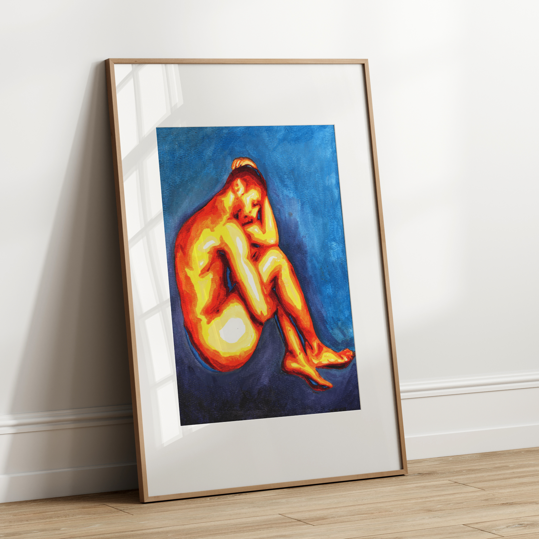 Framed artwork of a nude figure on a white wall