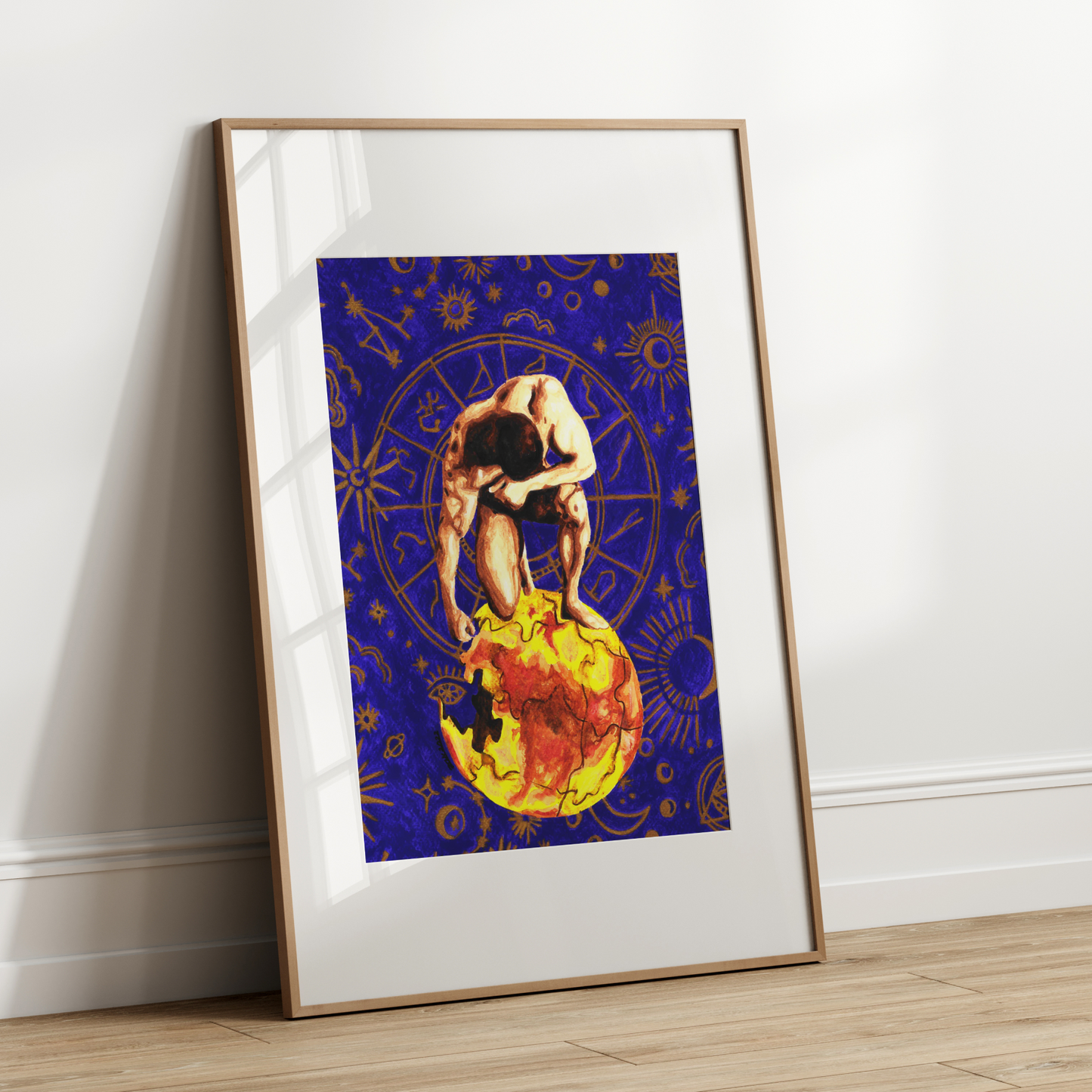 Framed artwork of a person sitting on a moon with starry background on a white wall.