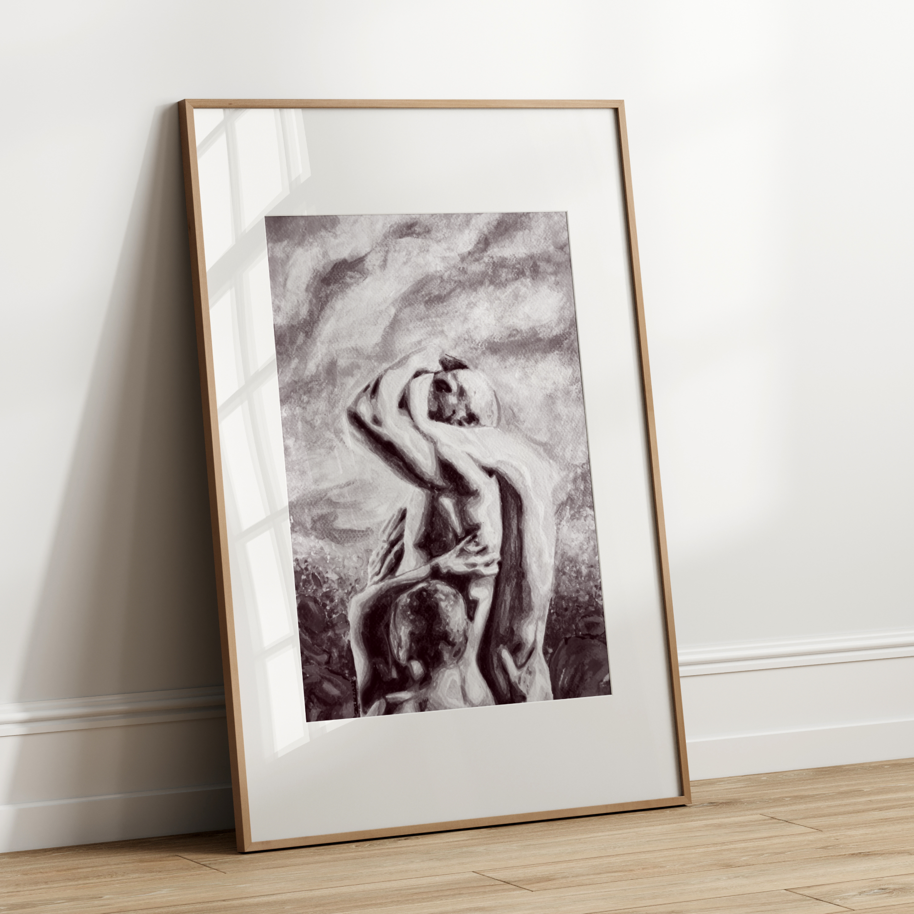 Framed black and white artwork of a nude figure leaning against a wall.