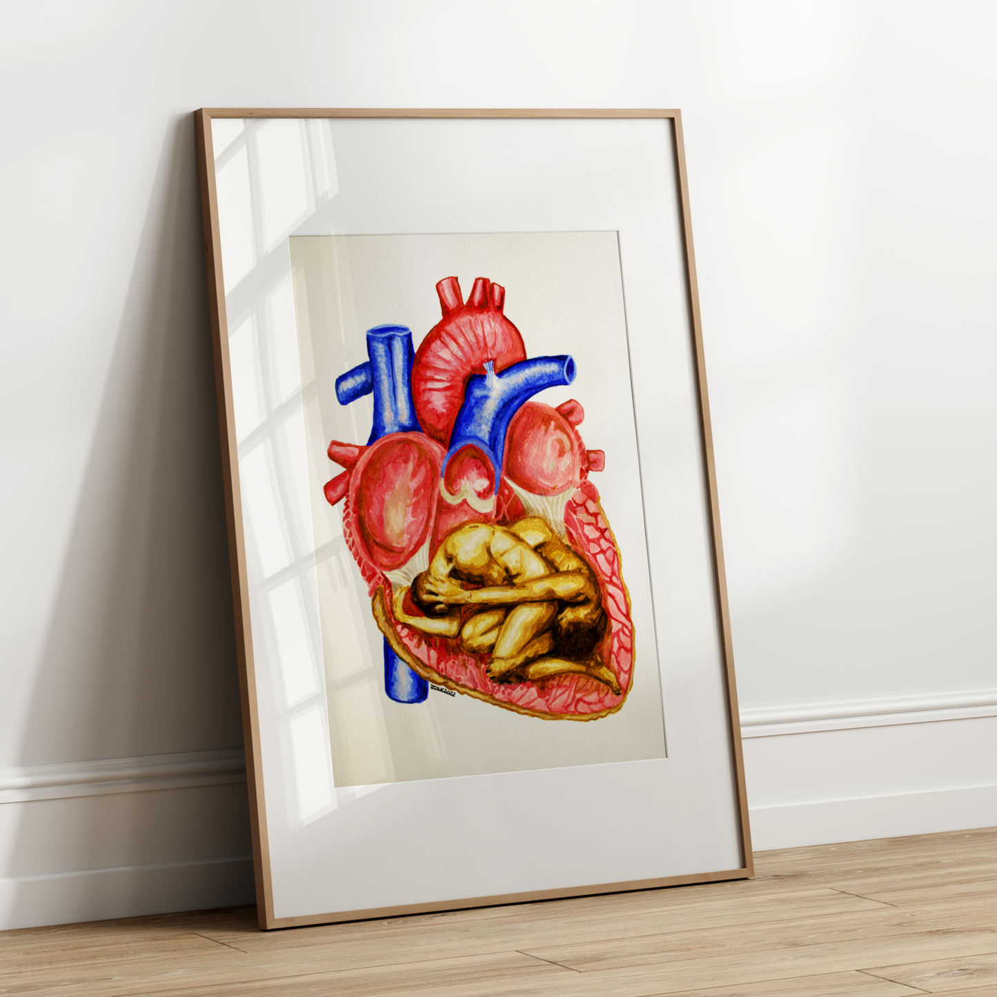 Framed illustration of a human heart on a white wall.
