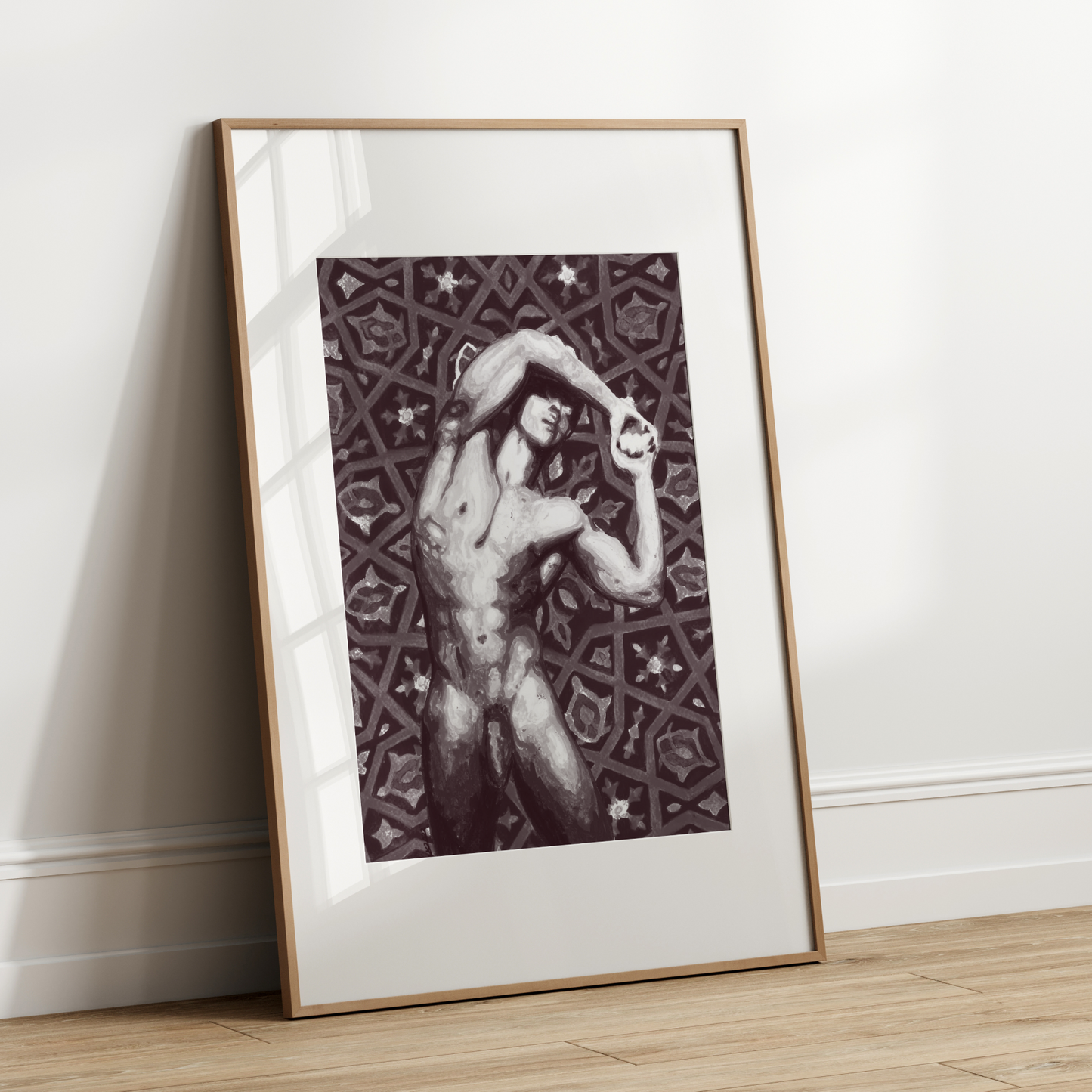 Framed artwork of a nude figure against a geometric pattern on a white wall.