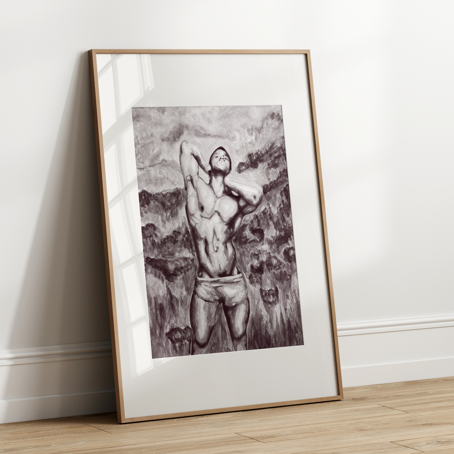 Framed black and white artwork of a person against a plain wall.