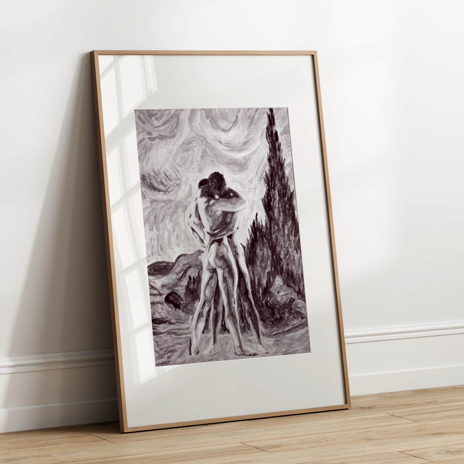 Framed black and white artwork leaning against a white wall.