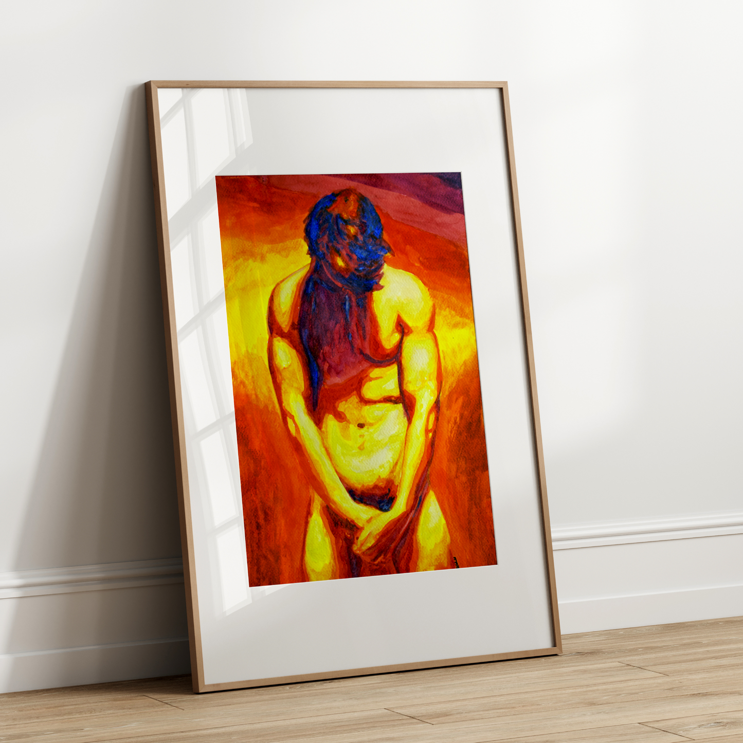 Framed artwork of a shirtless figure with vibrant colors leaning against a white wall.
