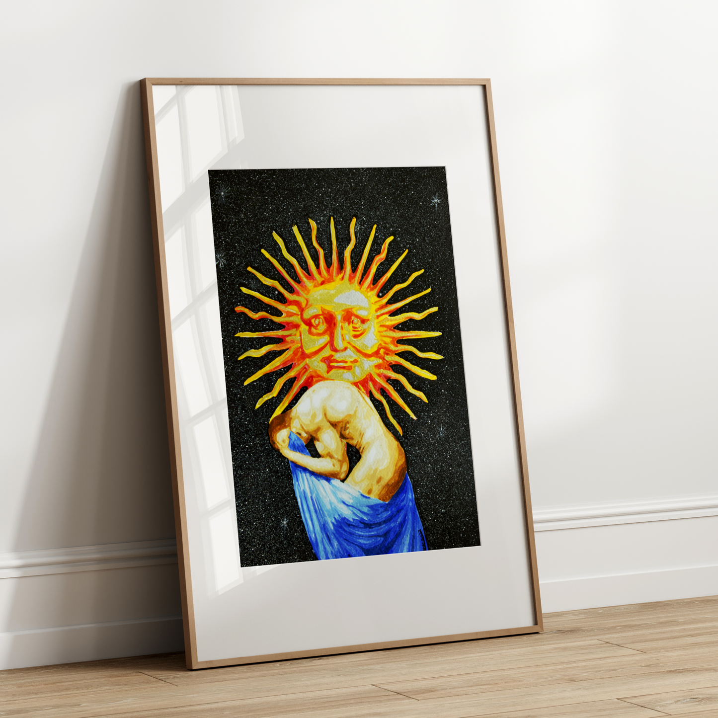 Framed artwork of a celestial design with a sun-like symbol on a white wall.