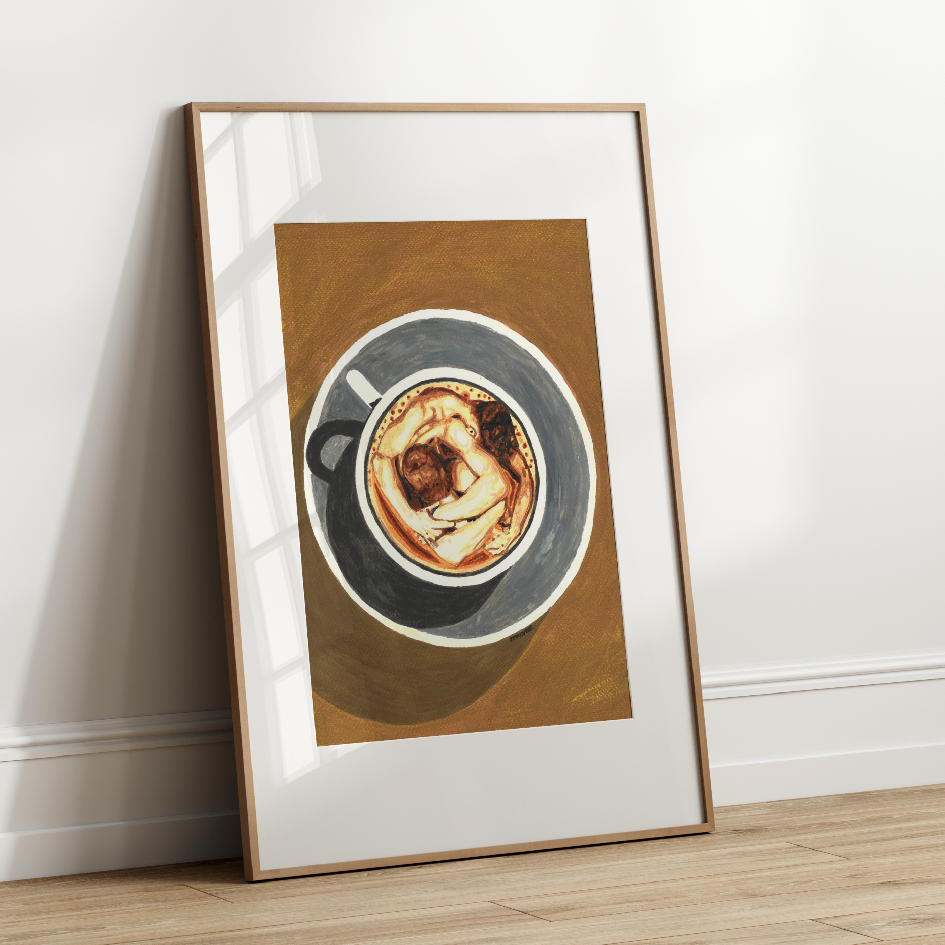 Framed artwork of a coffee cup with a wooden frame on a white wall.