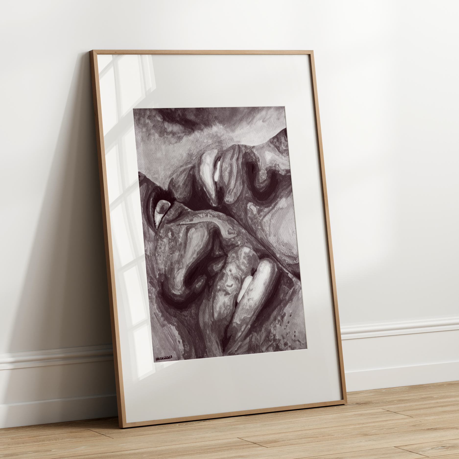 Framed black and white abstract art leaning against a white wall.
