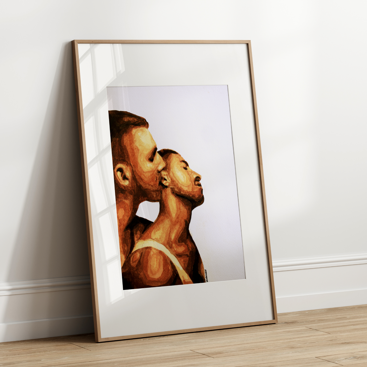 Framed artwork of two profiles on a white wall
