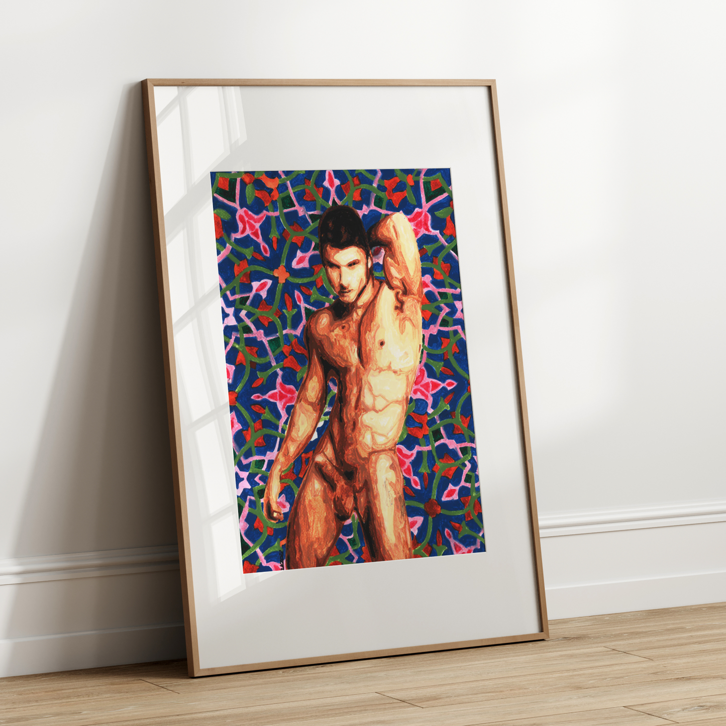 Framed artwork of a shirtless man against a colorful abstract background on a white wall.
