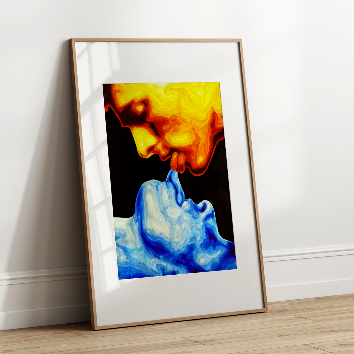 Framed abstract art print with colorful smoke design leaning against a white wall.