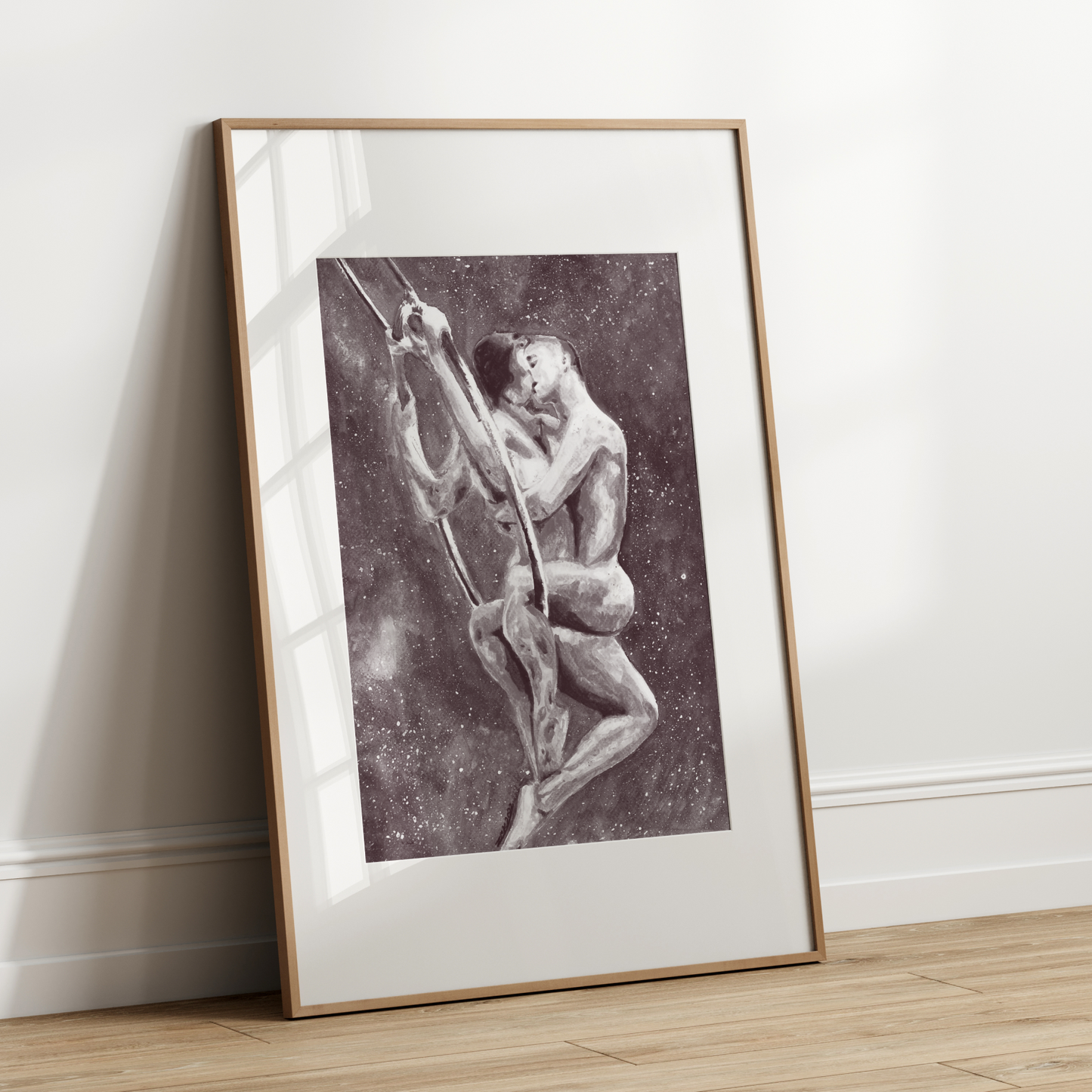Framed artwork of a person climbing a mountain on a white wall.
