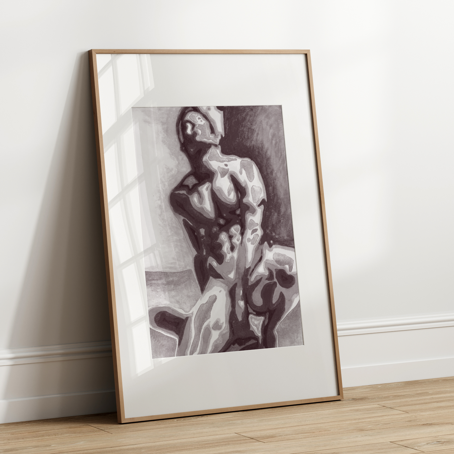 Framed artwork of a classical statue leaning against a white wall.